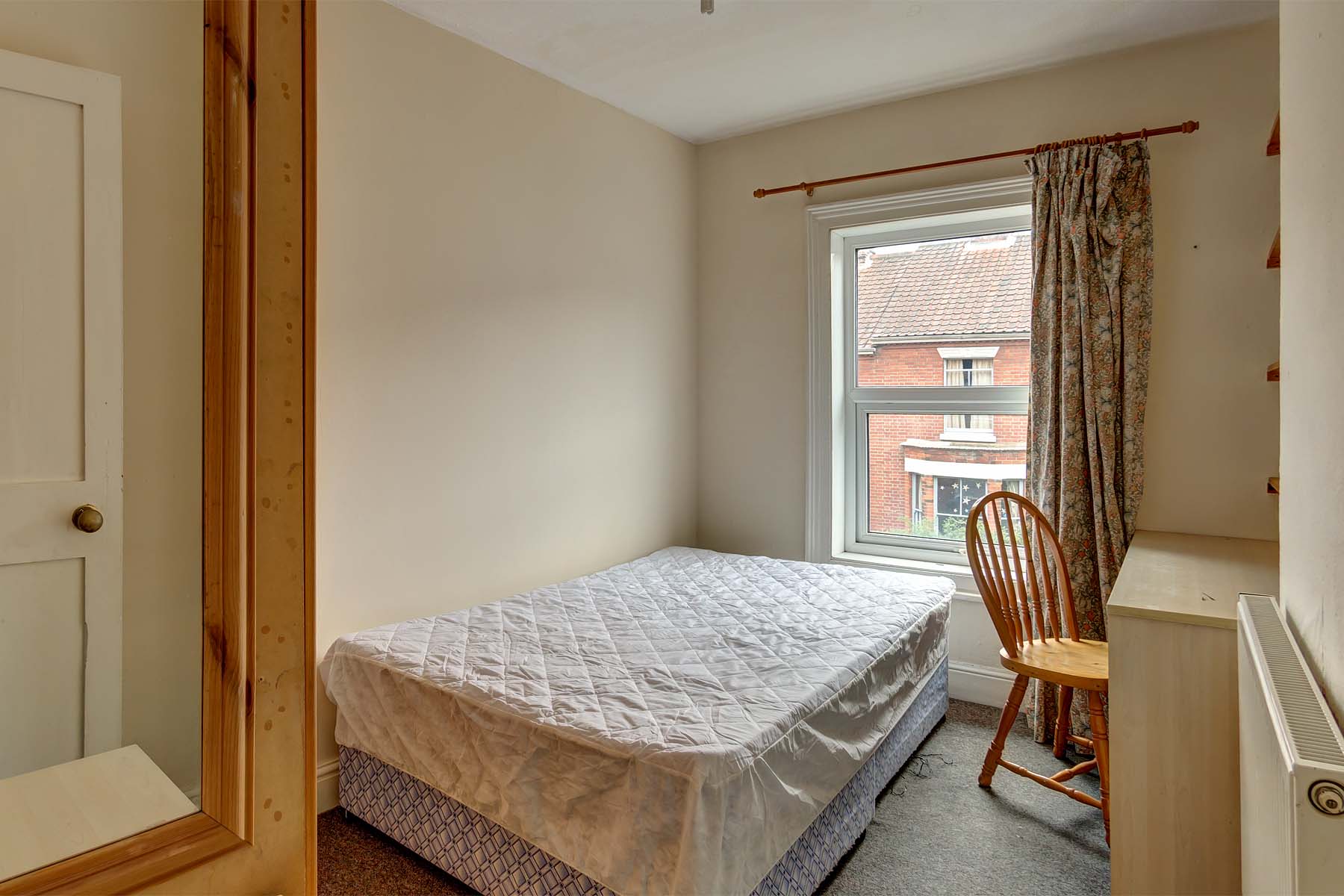 Bedroom with double bed and wooden furnishings