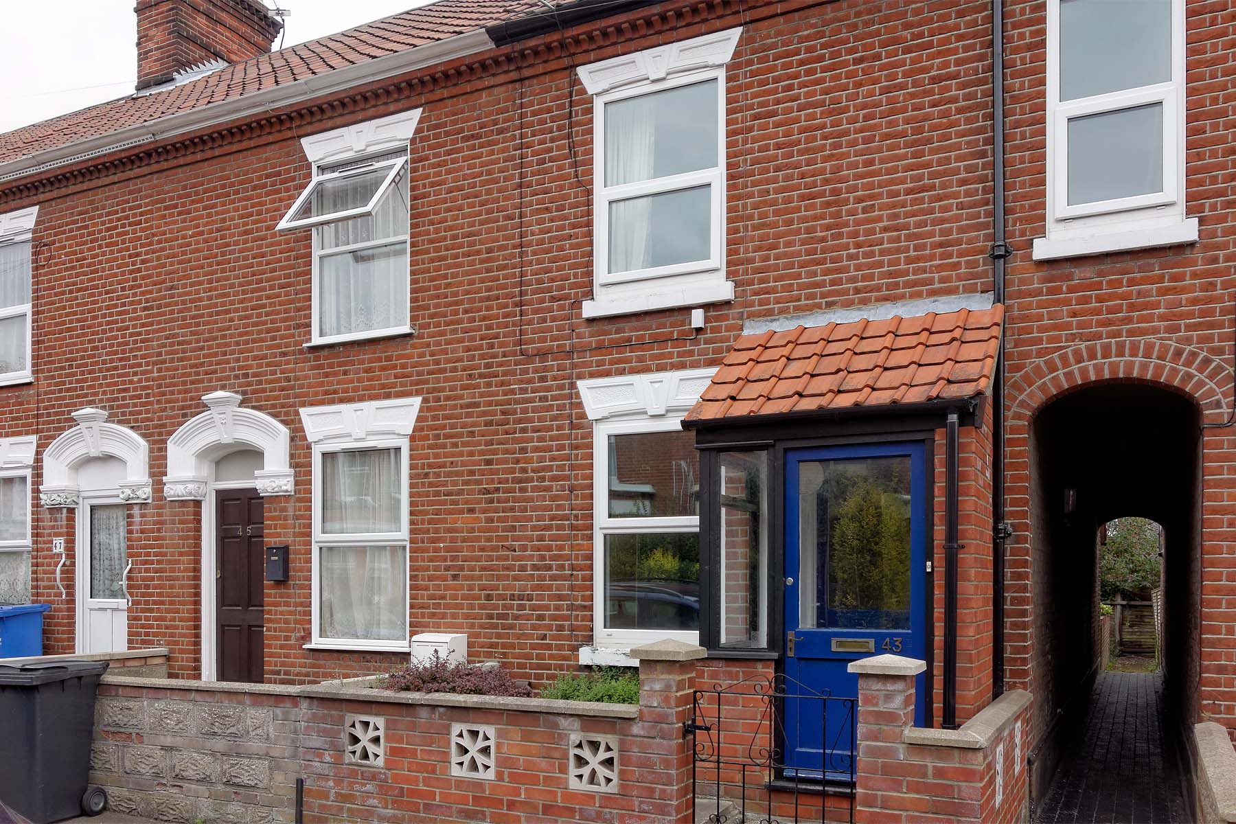 Red brick terraced house with front porch