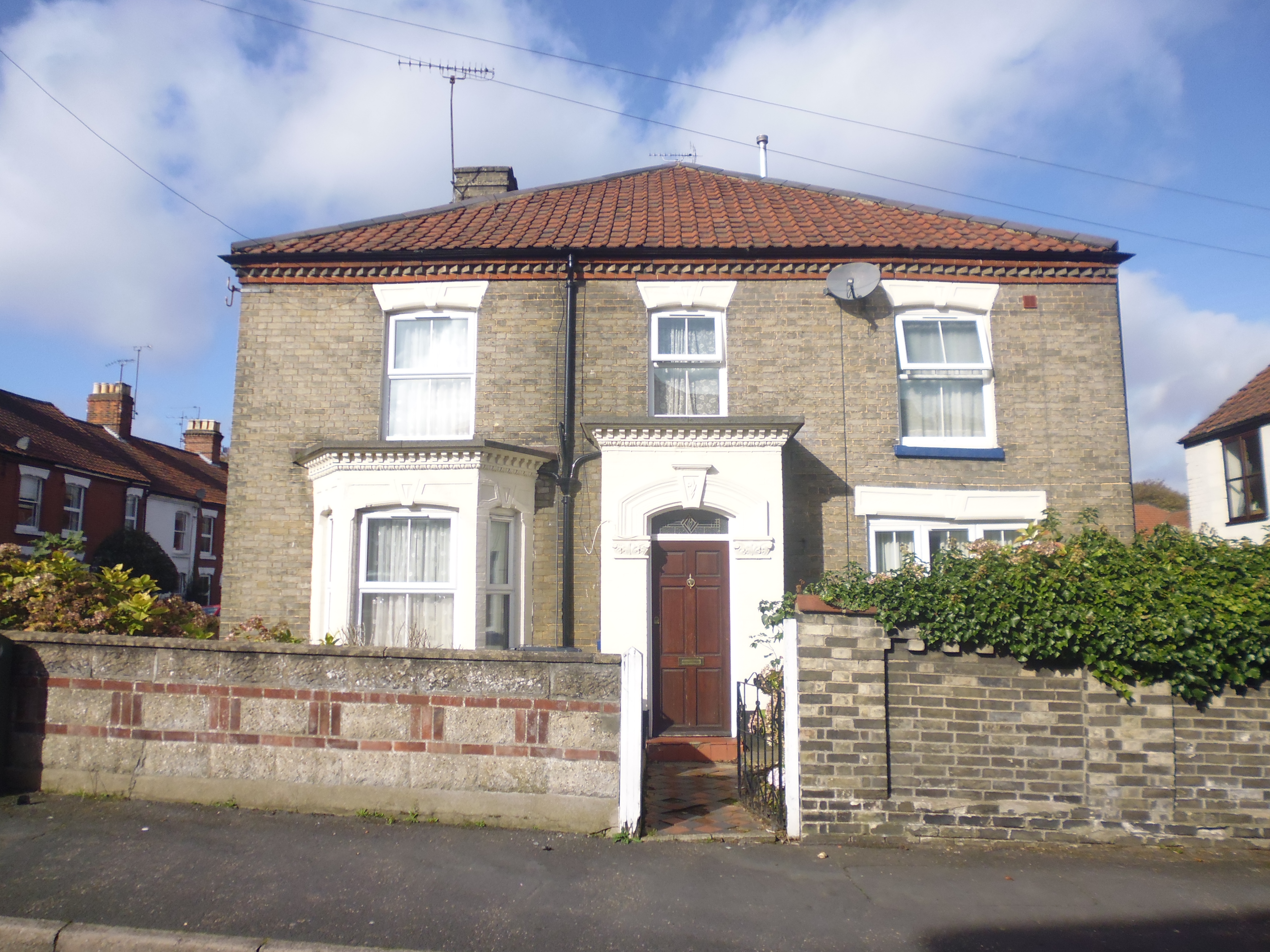 Detached Victorian grey brick house