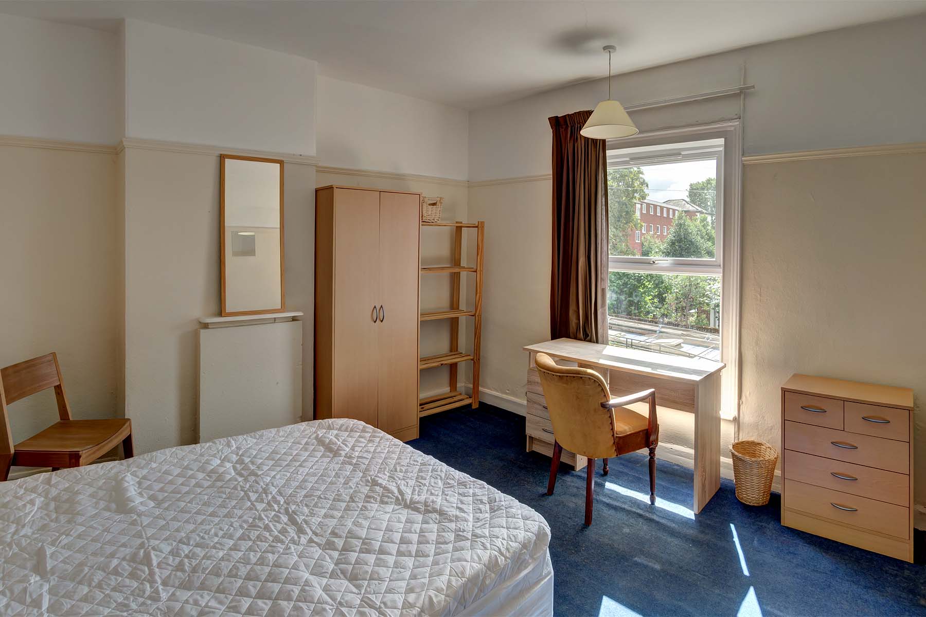 Bedroom with double bed and wooden furnishings