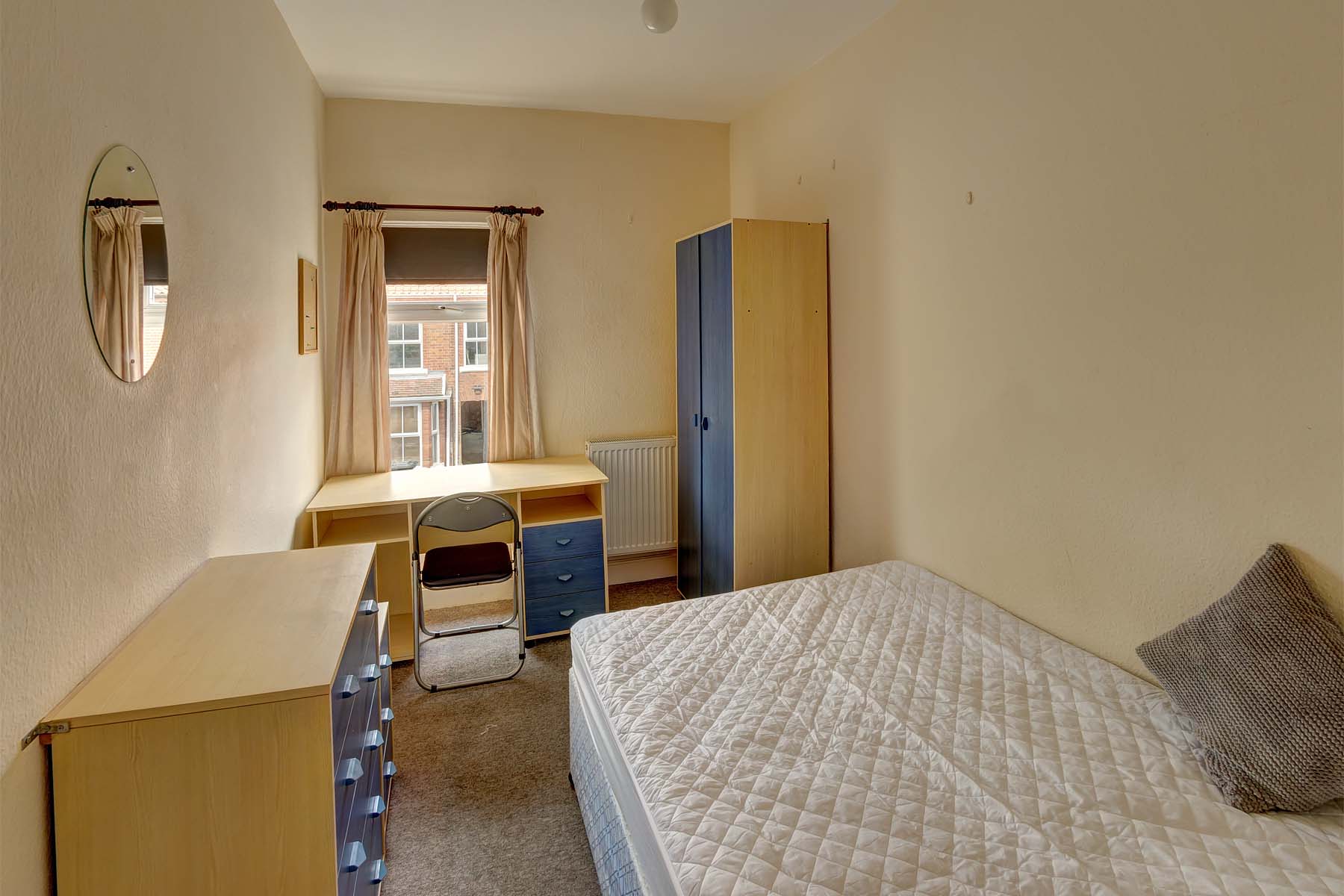 Bedroom with double bed and wooden furnishings