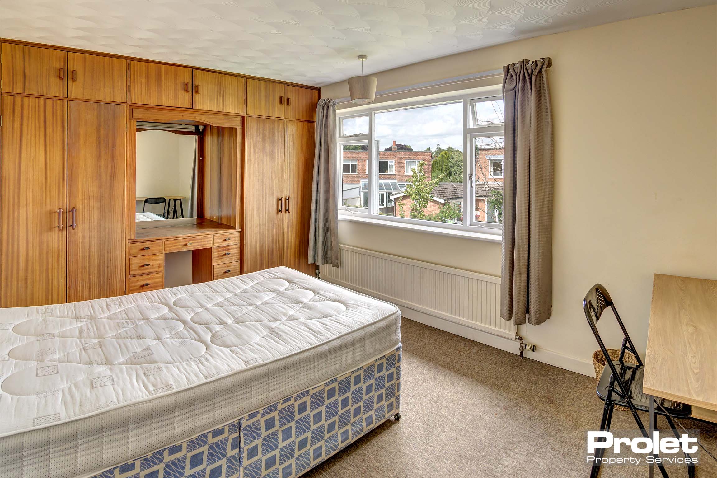 Bedroom with double bed and built in storage