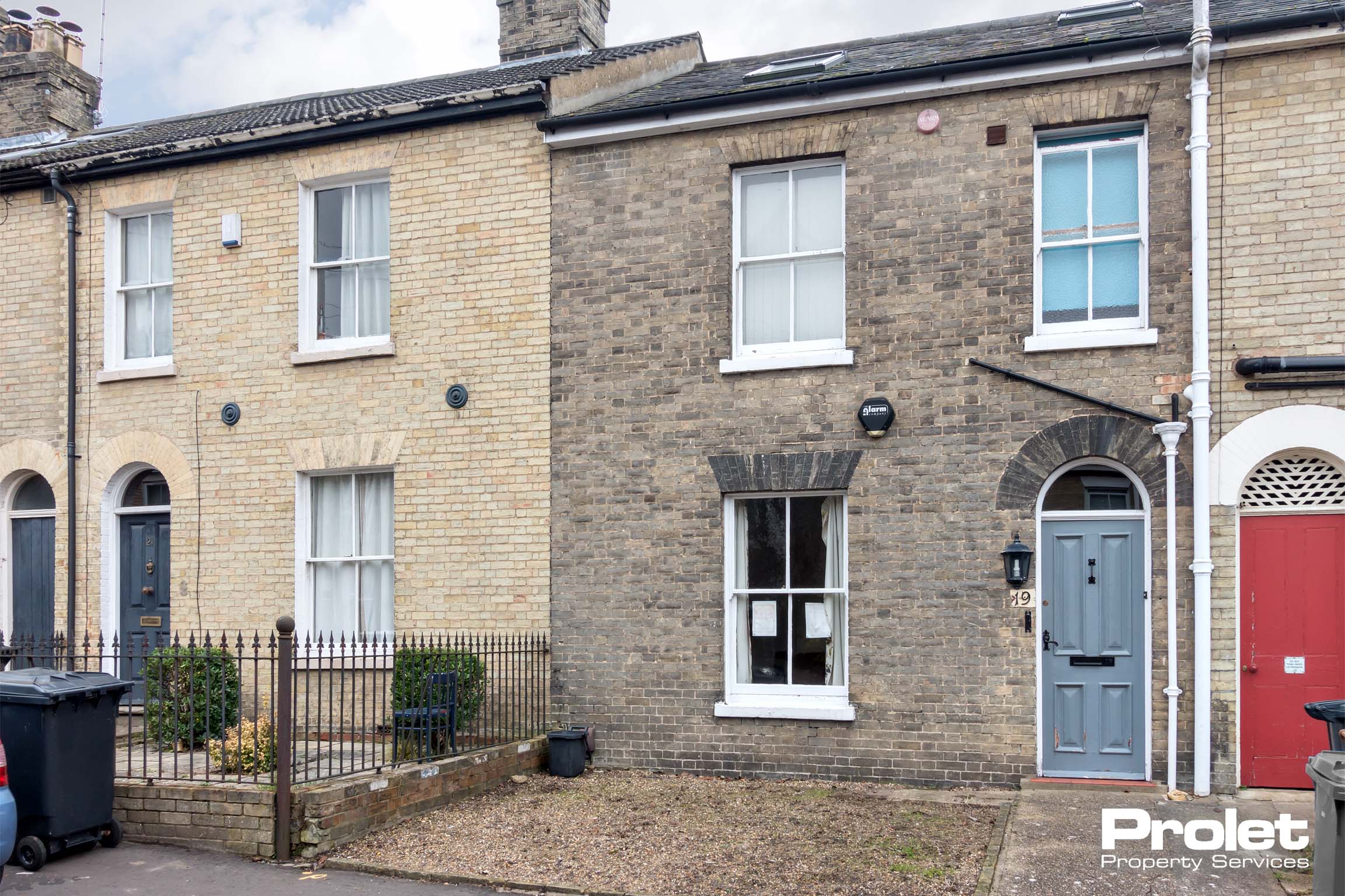 Grey brick Victorian terrace with light blue door