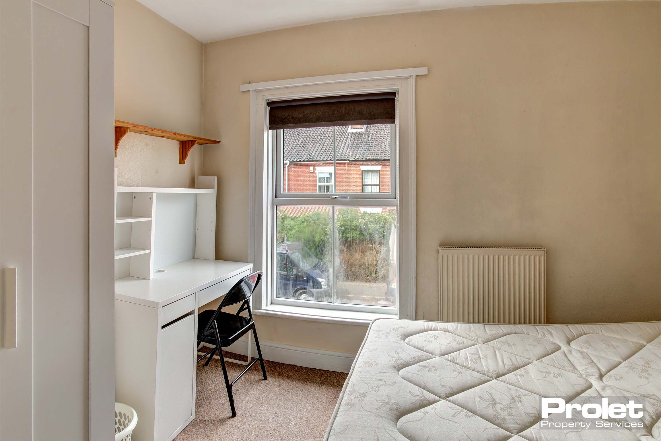 Bedroom with double bed and white desk