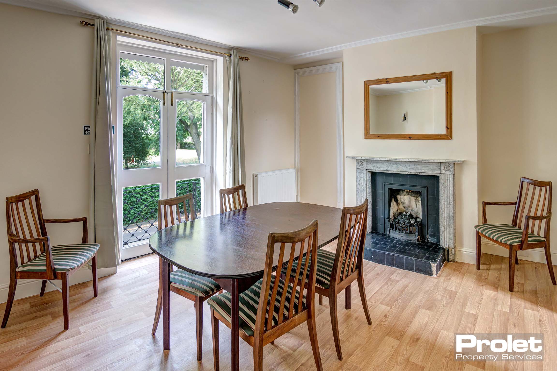 Dining room with dining table set and period fireplace. and