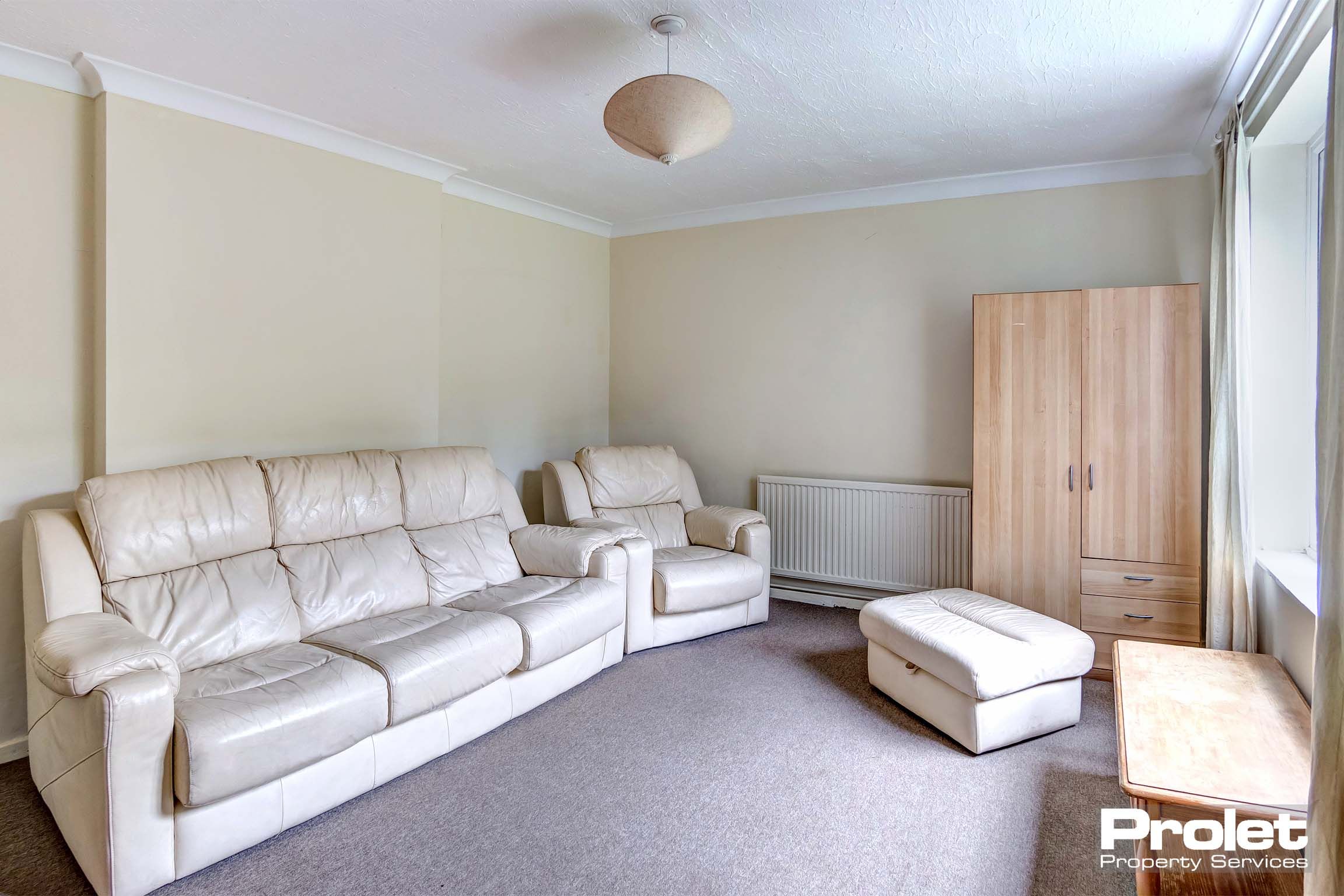 Living room with white leather affect sofa suite