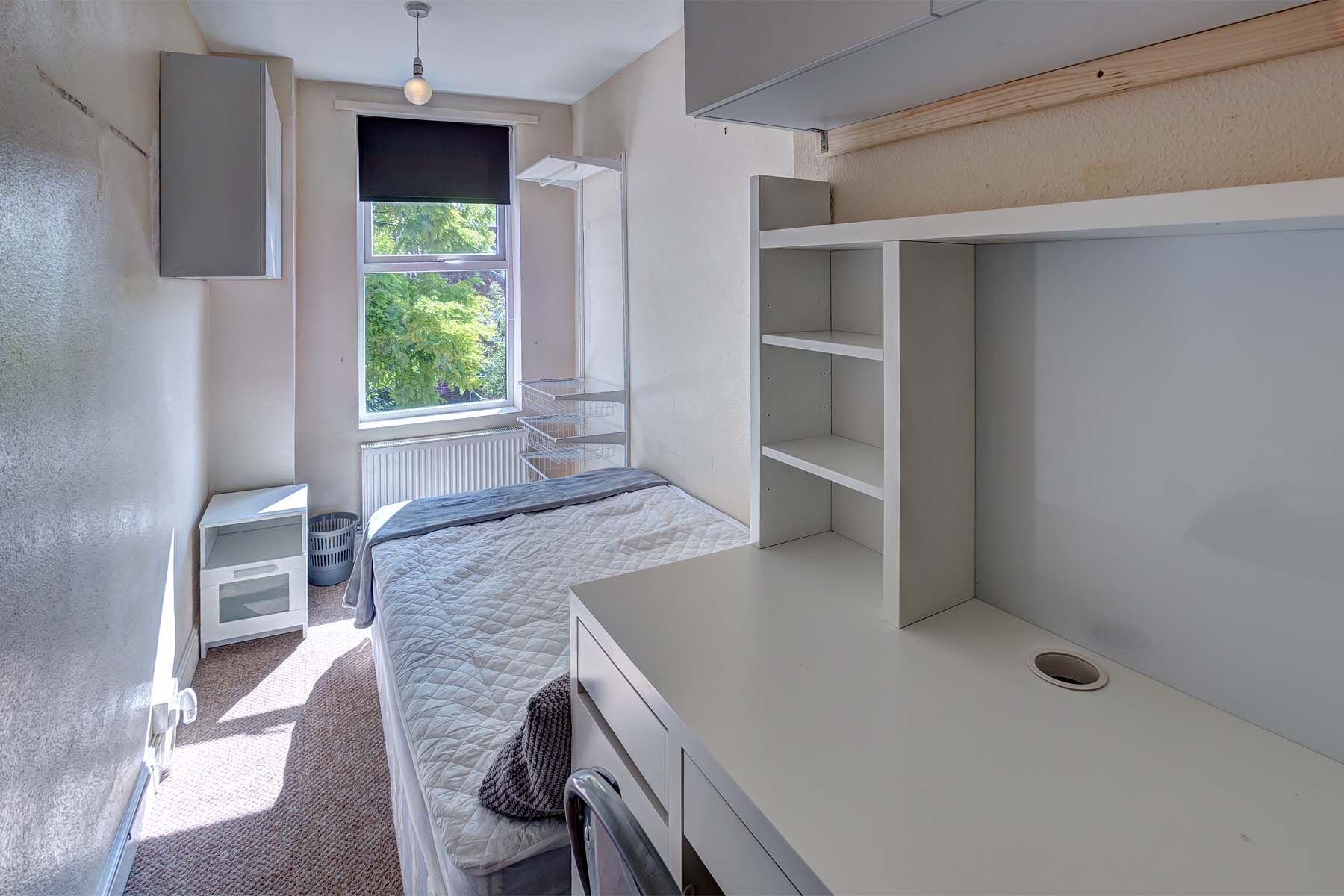 Bedroom with double bed and white desk
