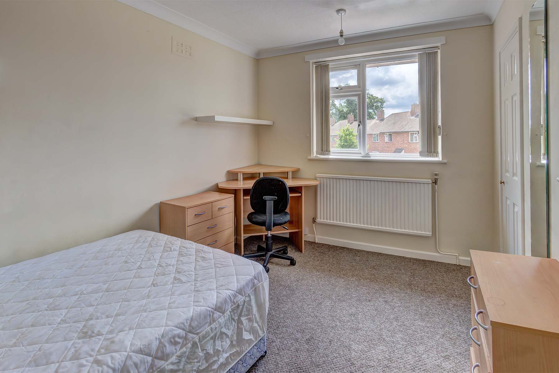 Bedroom with double bed and desk