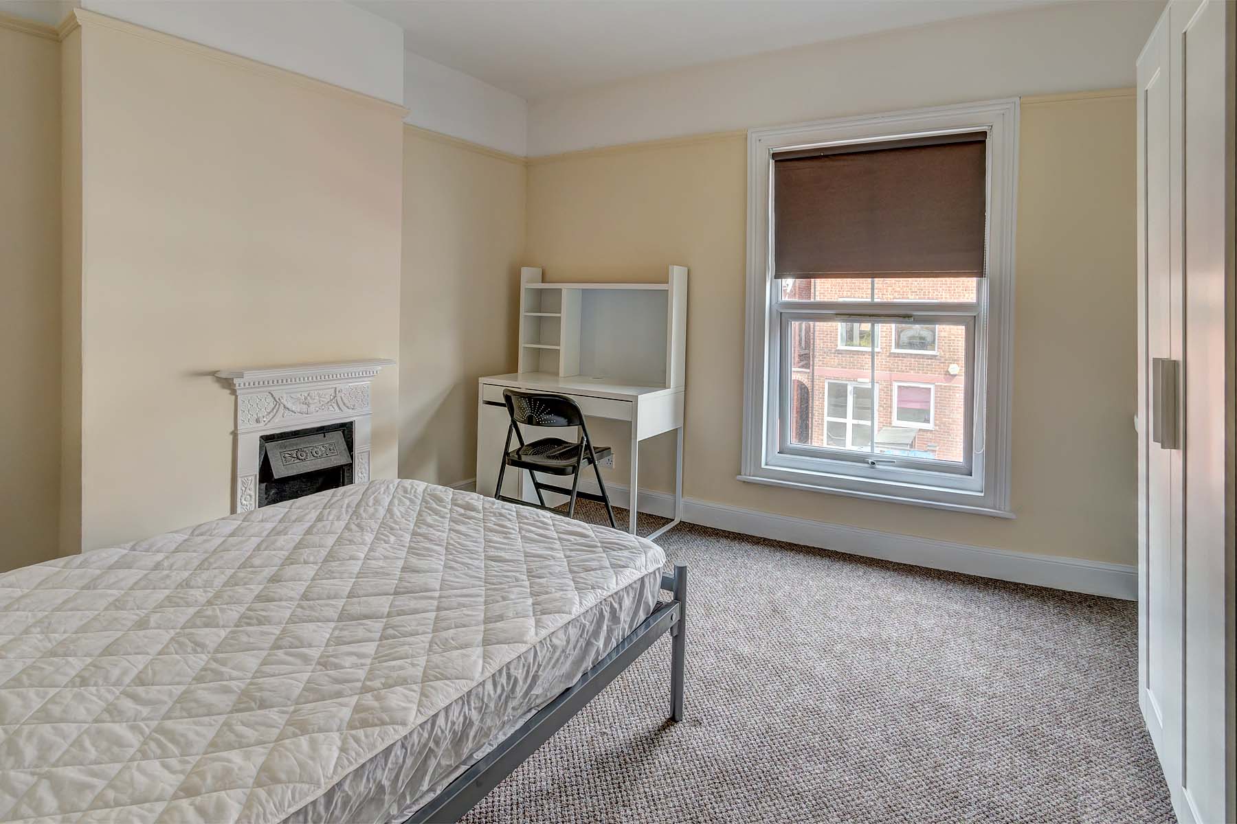 Large bedroom with double bed and desk