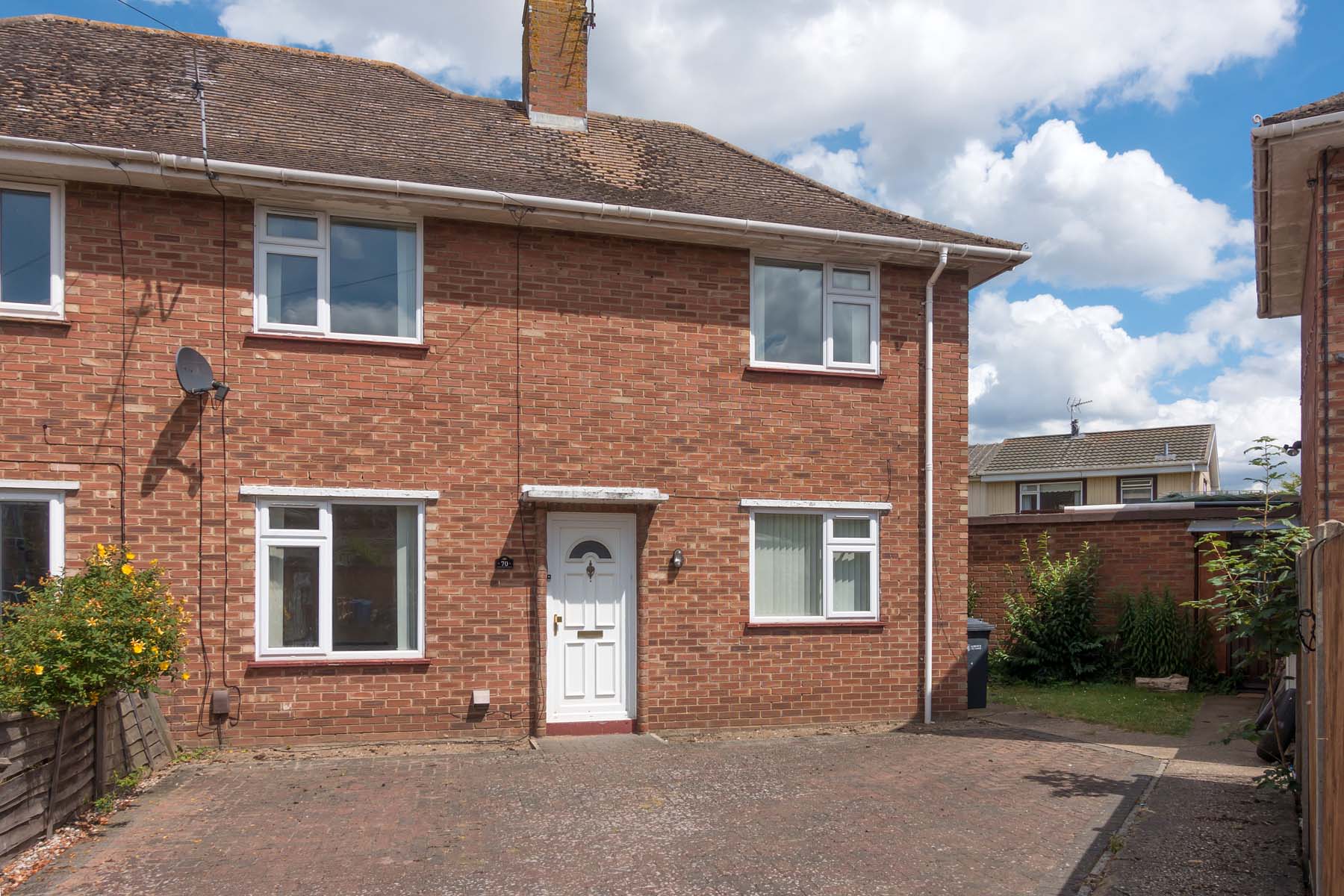 Red brick semi-detached house with large driveway