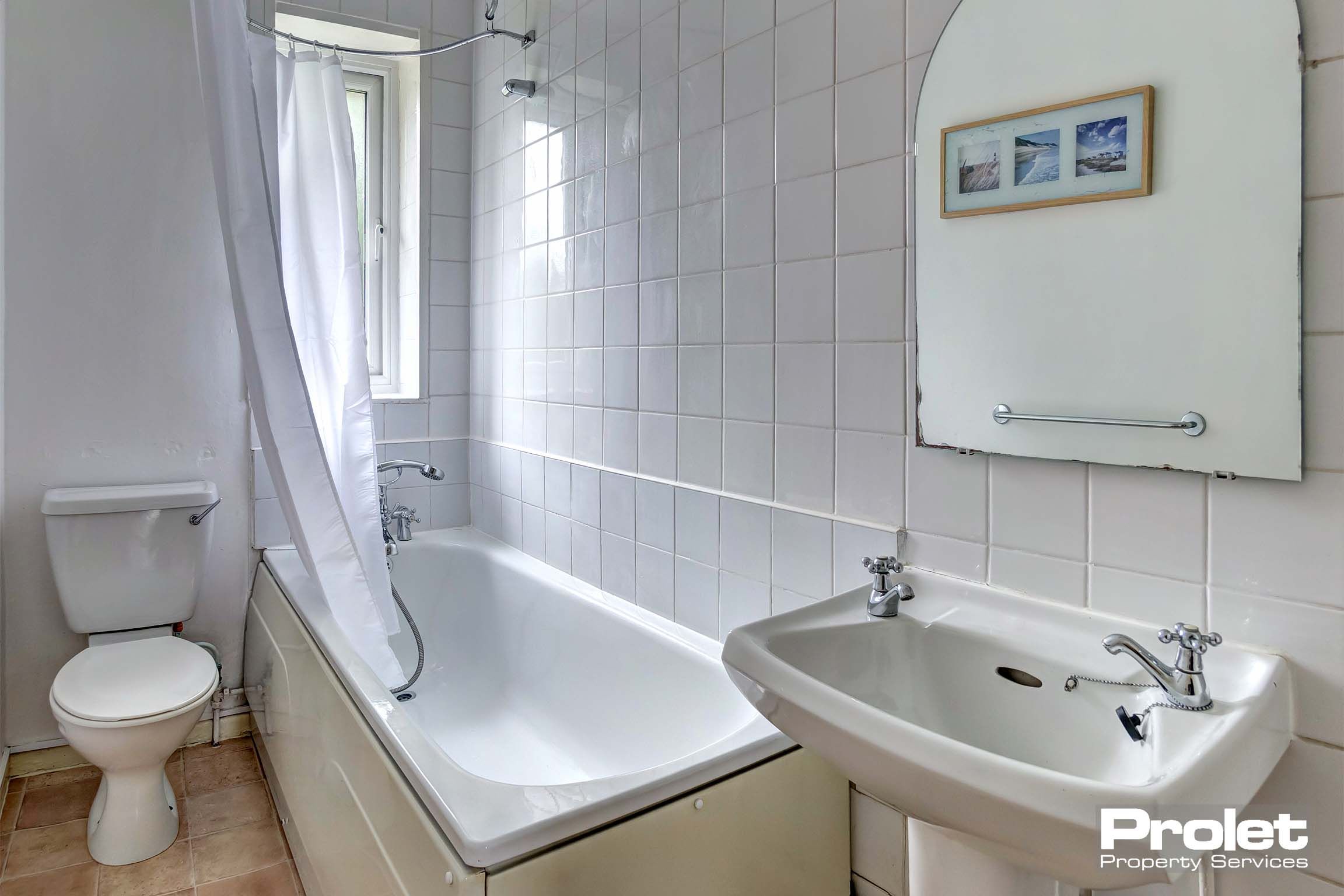 Bathroom with shower over bath and sink