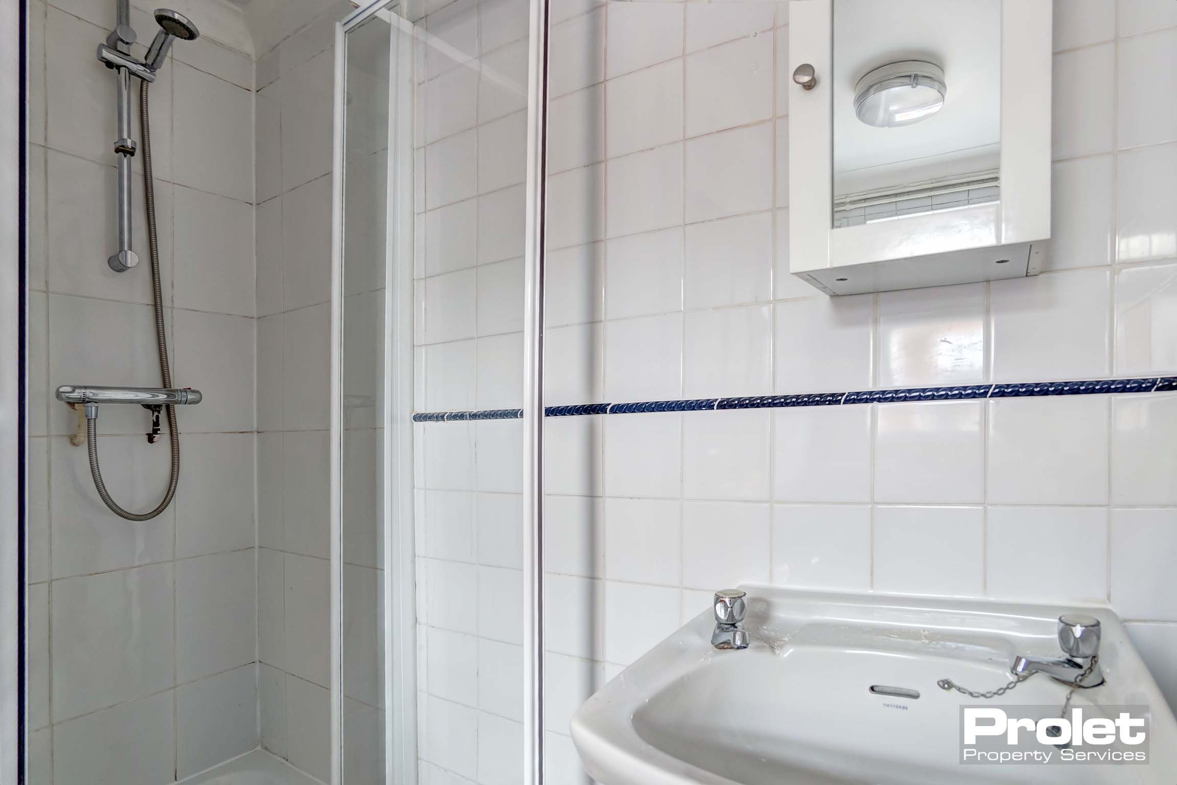 Bathroom with shower cubicle and sink