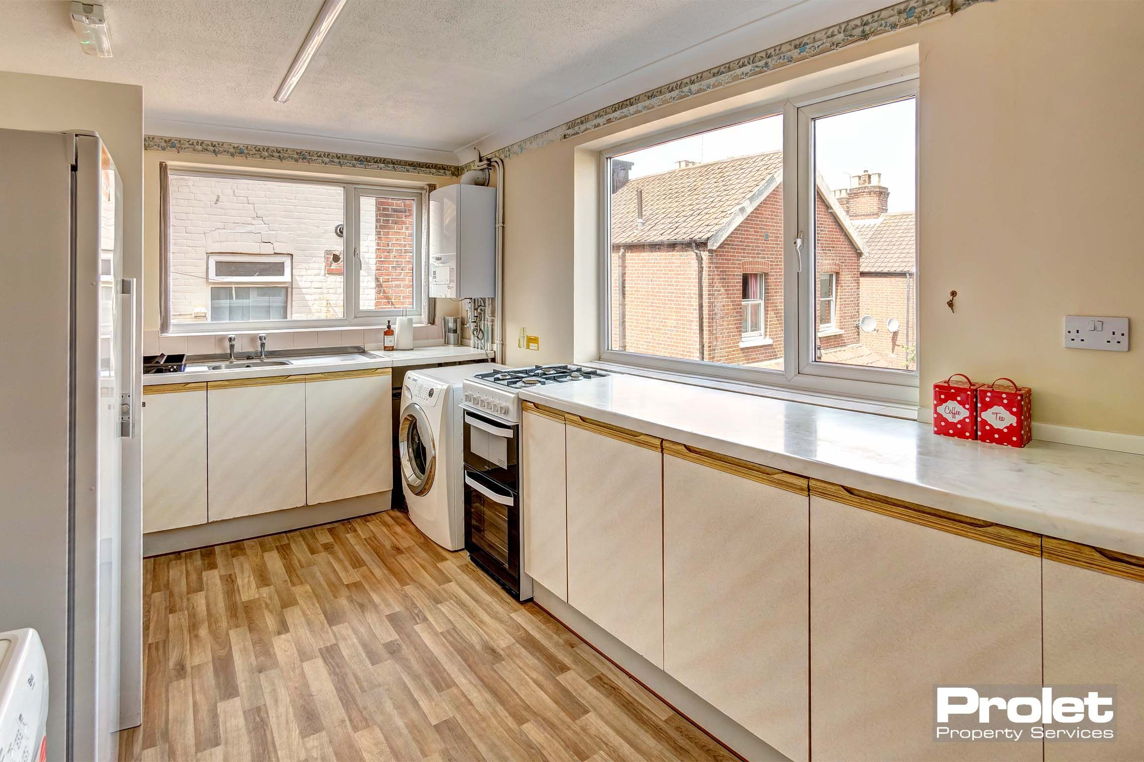 Kitchen with white units and white goods