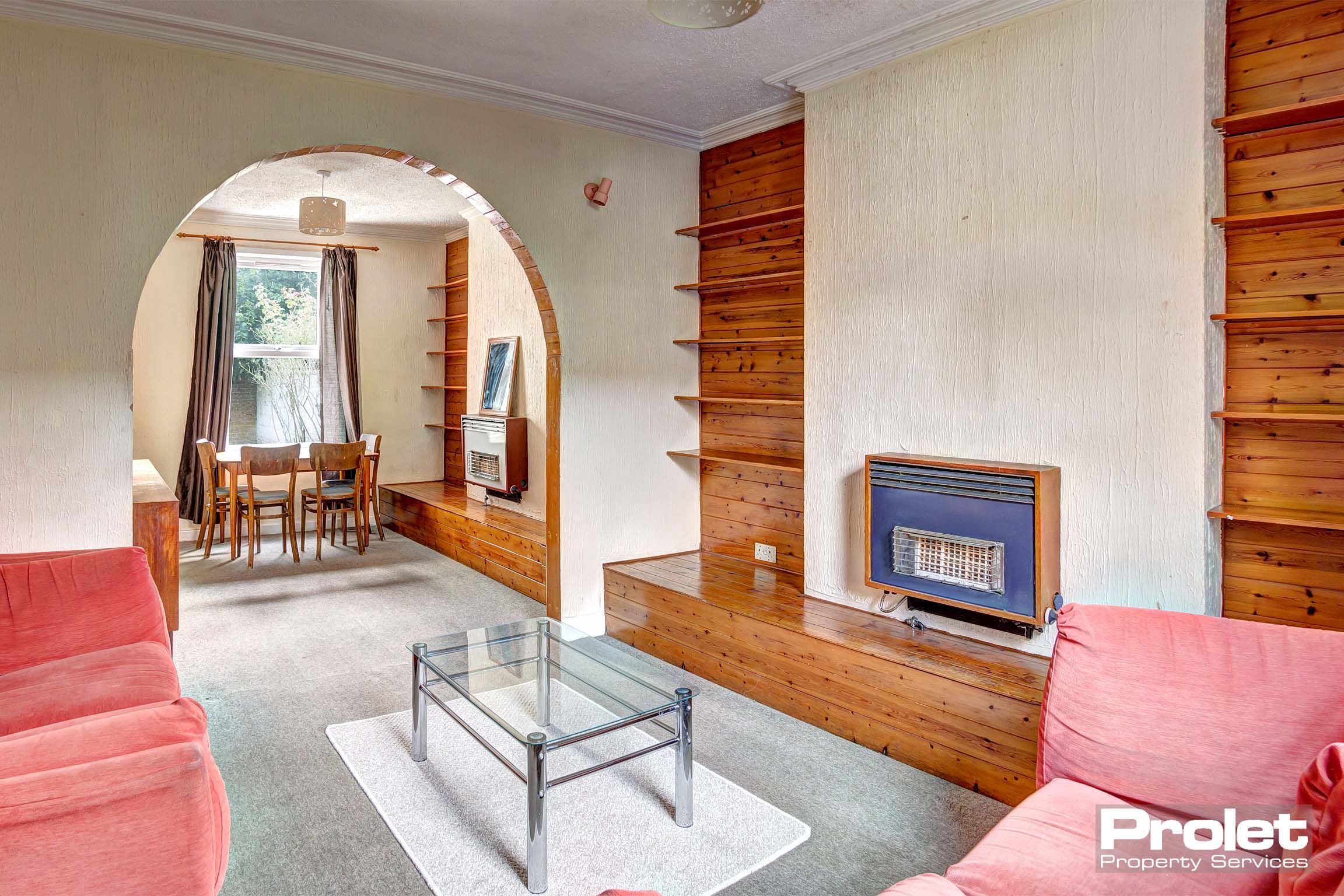 Living room and dining area with sofas, coffee table, and dining set