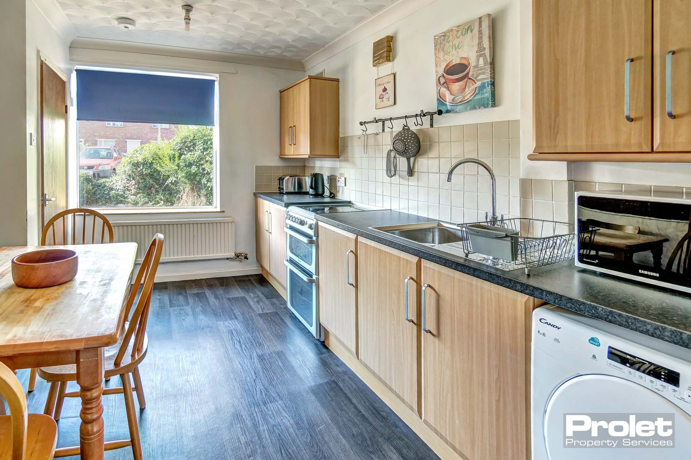 Wooden fitted kitchen with wooden dining table