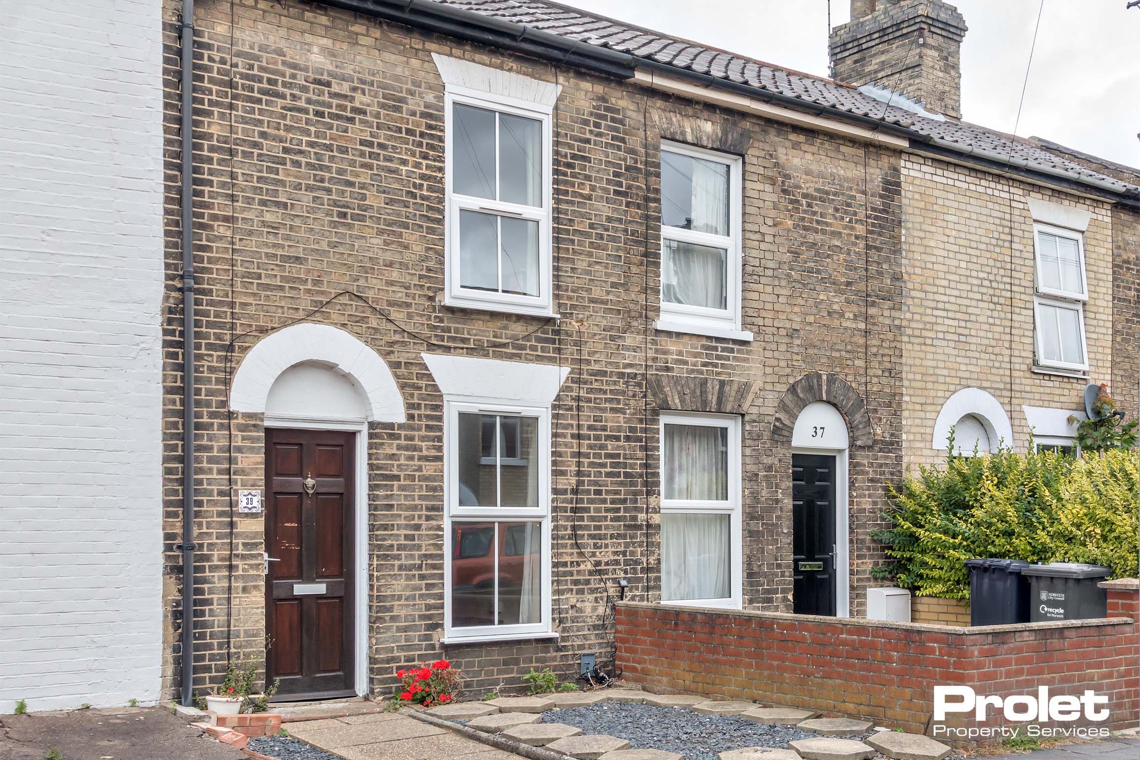 Brick terraced house with brown door