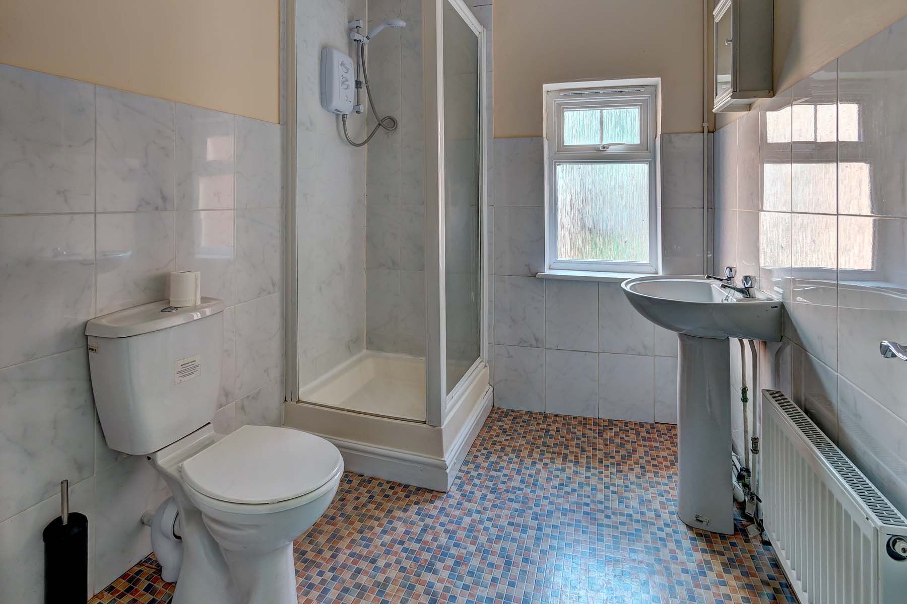 Bathroom with shower cubicle, toilet, and sink