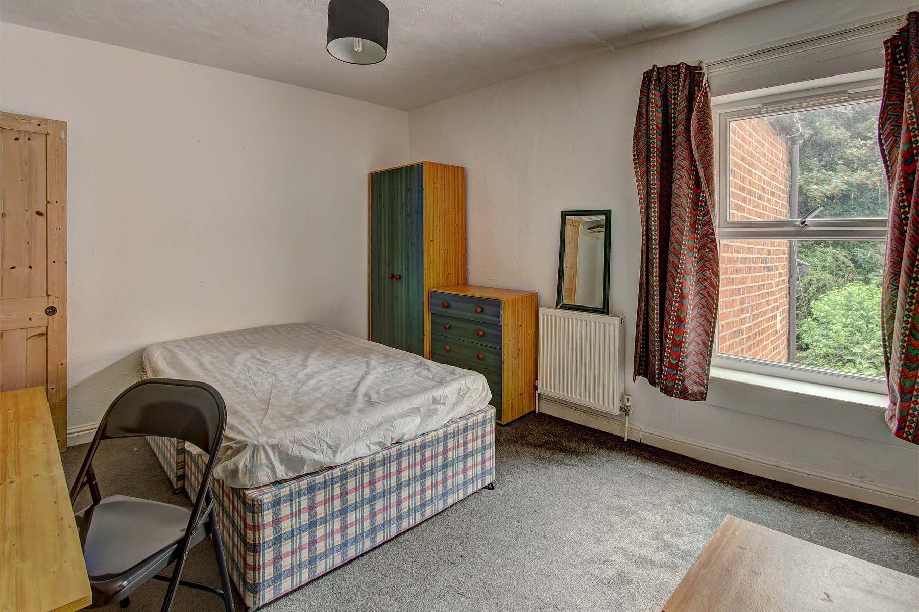 Bedroom with double bed and wooden furnishings