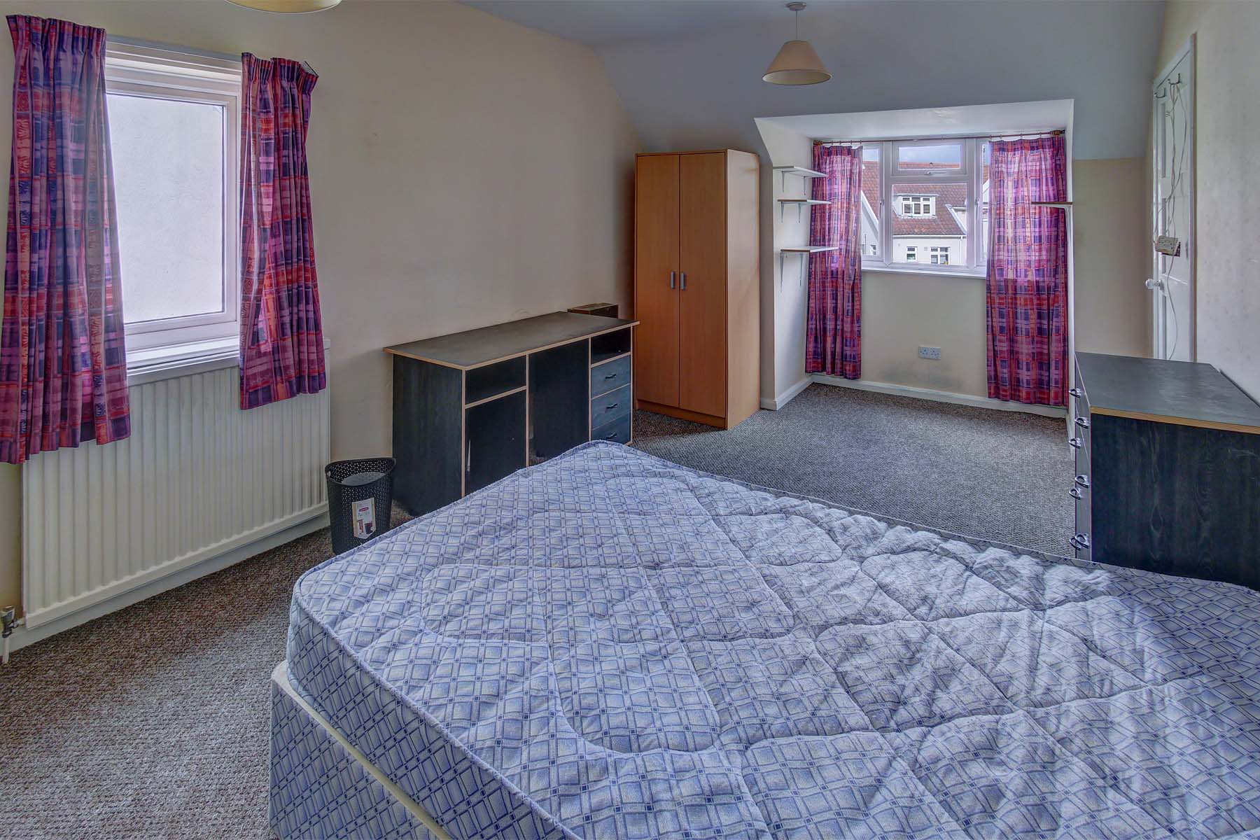 Bedroom with double bed and wooden furnishings