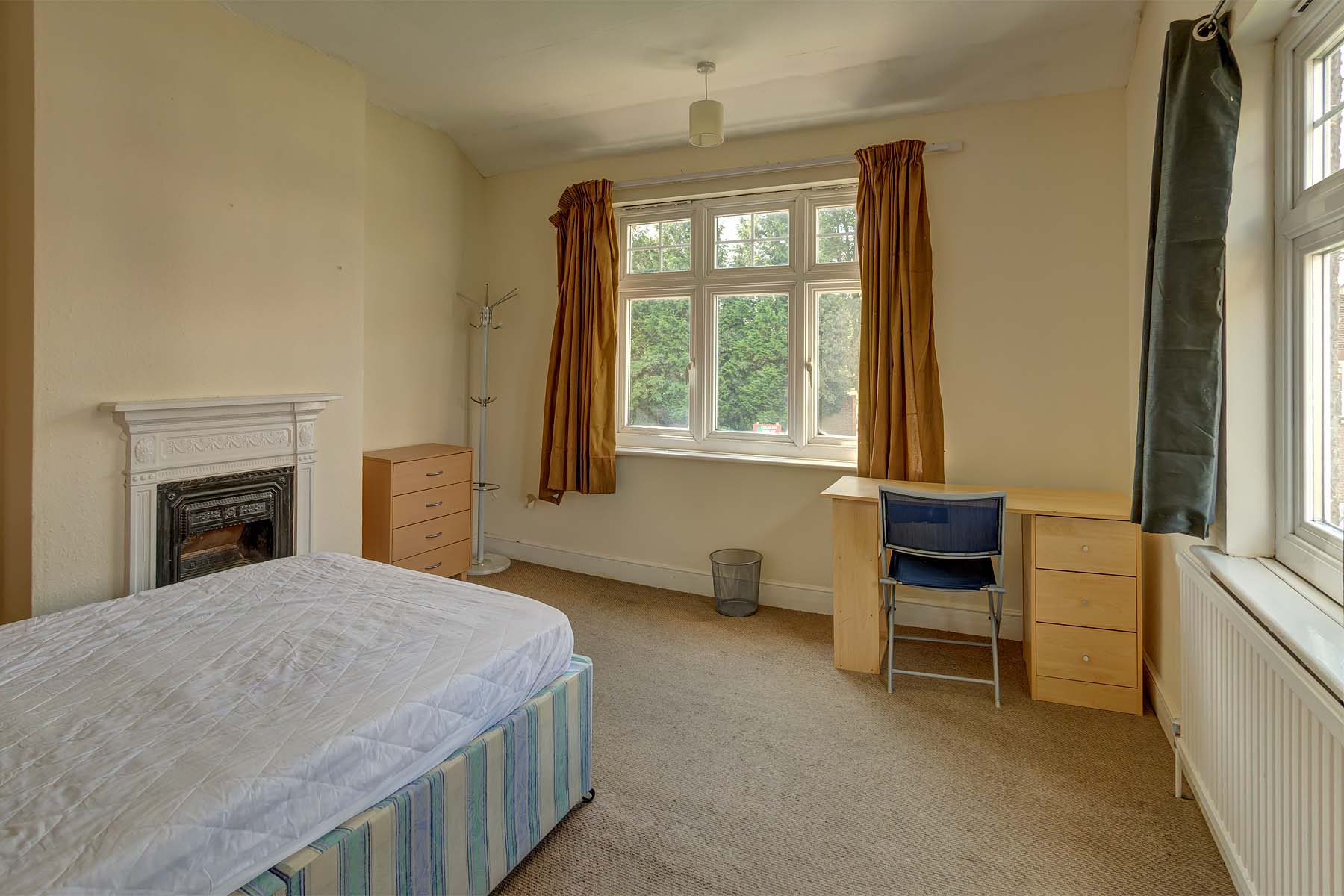 Large bedroom with double bed and wooden furnishings