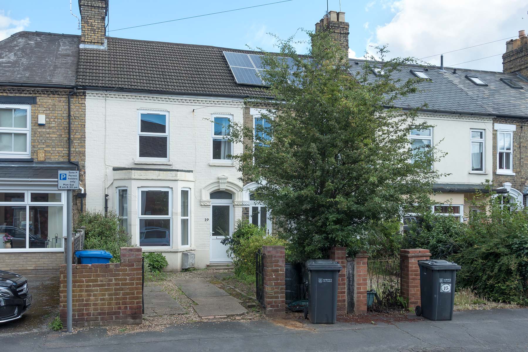 White painted terraced house with driveway
