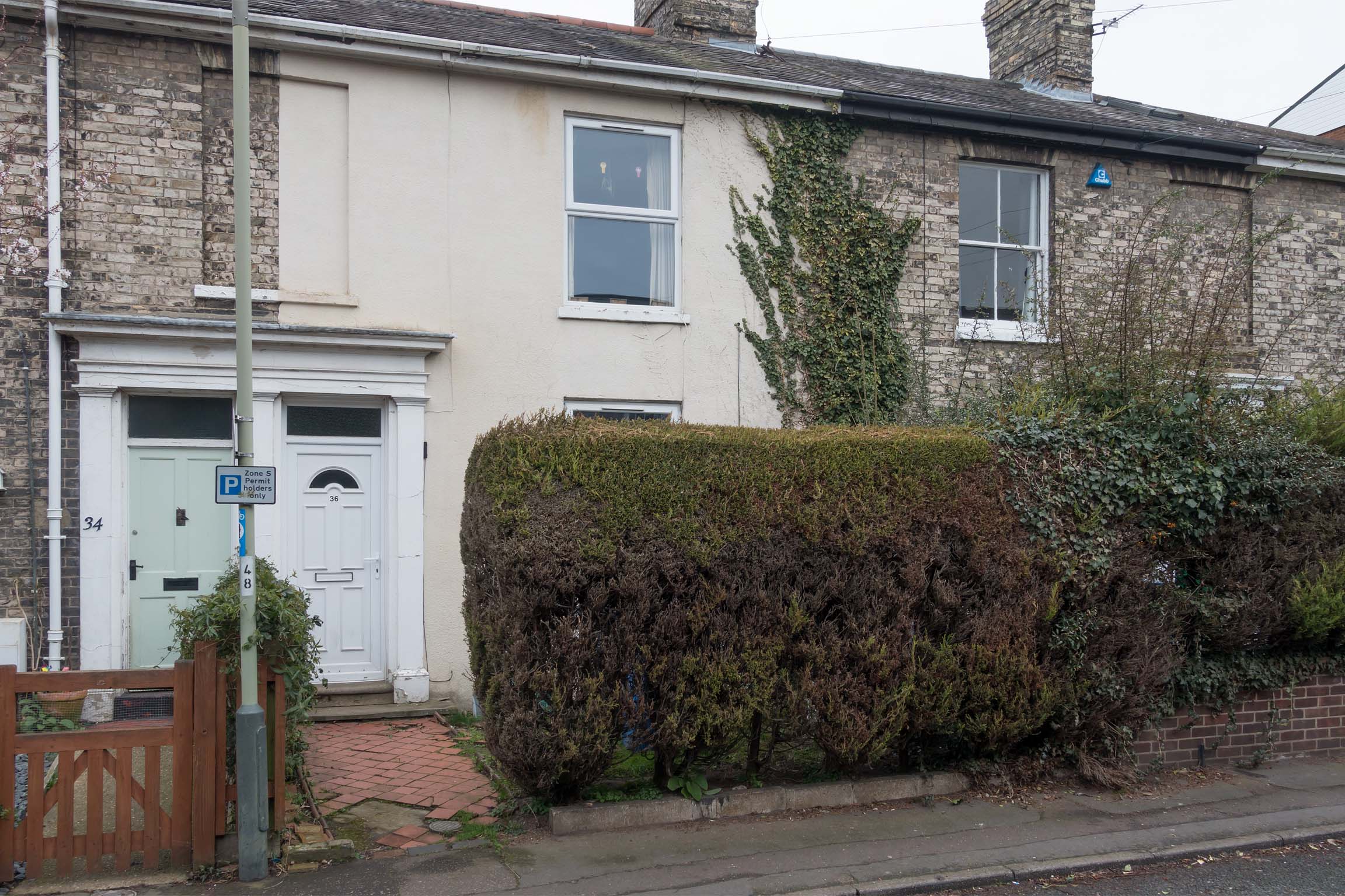 White painted terraced house with white front door