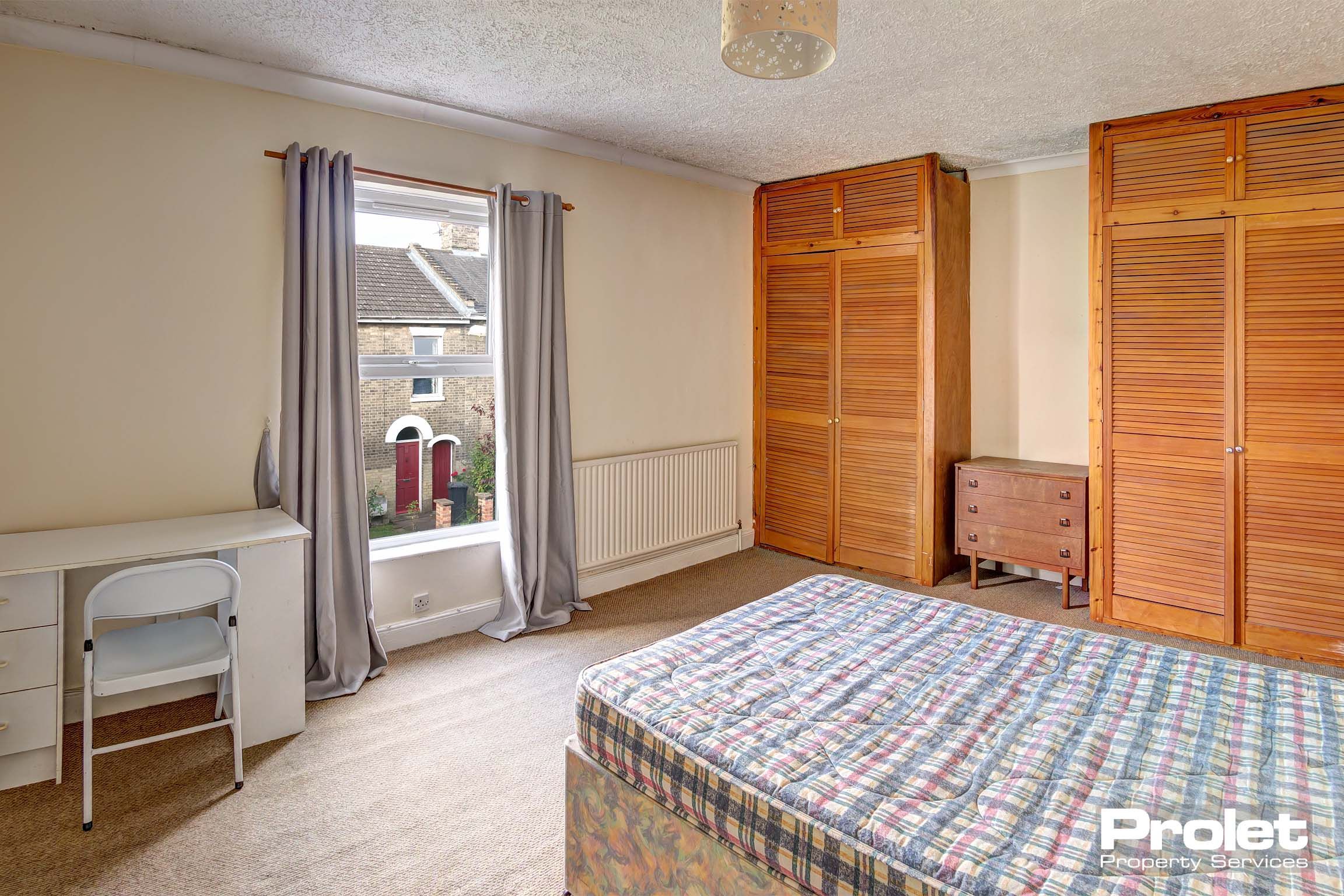 Bedroom with double bed and built in wardrobes