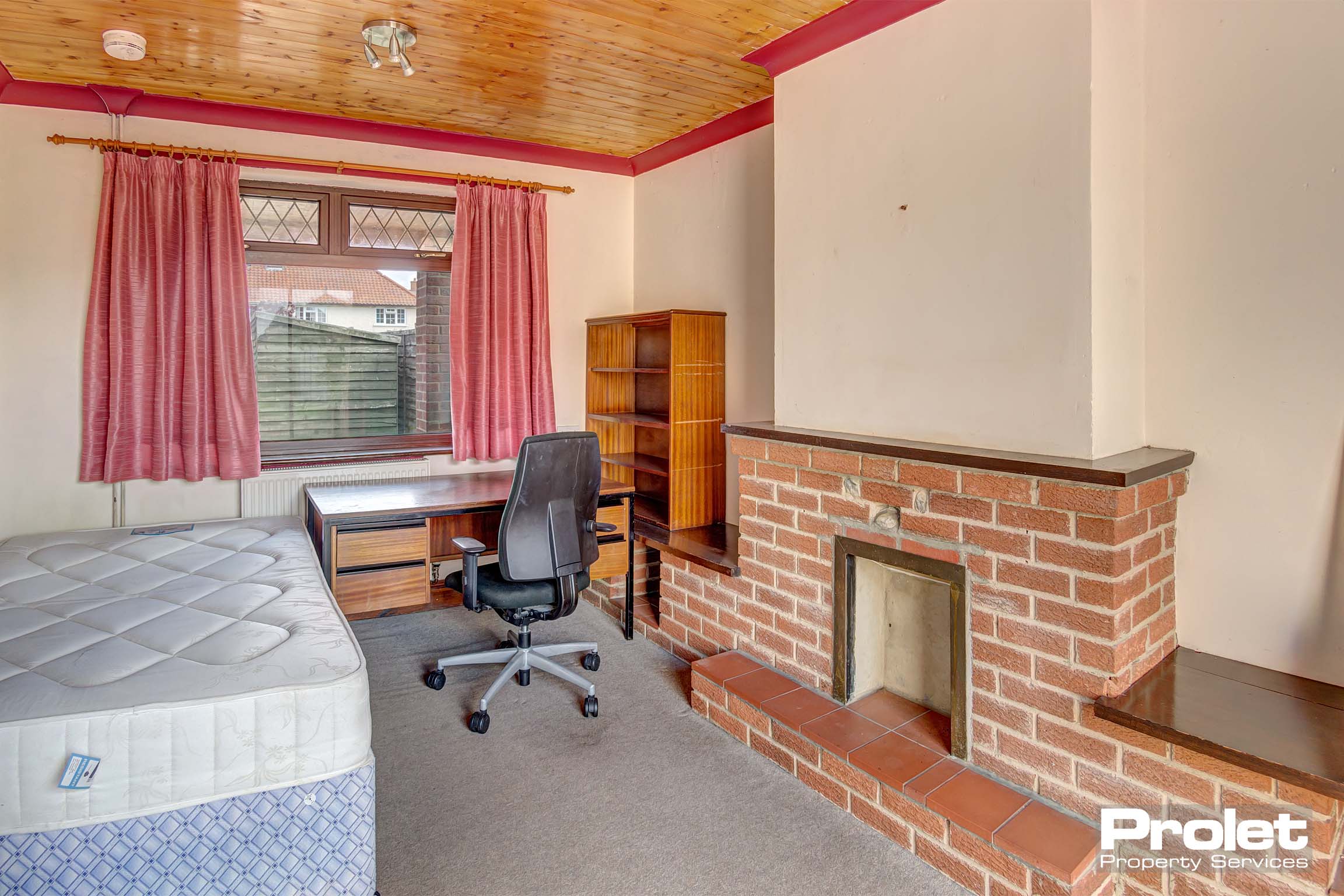 Bedroom with double bed and wooden furnishings