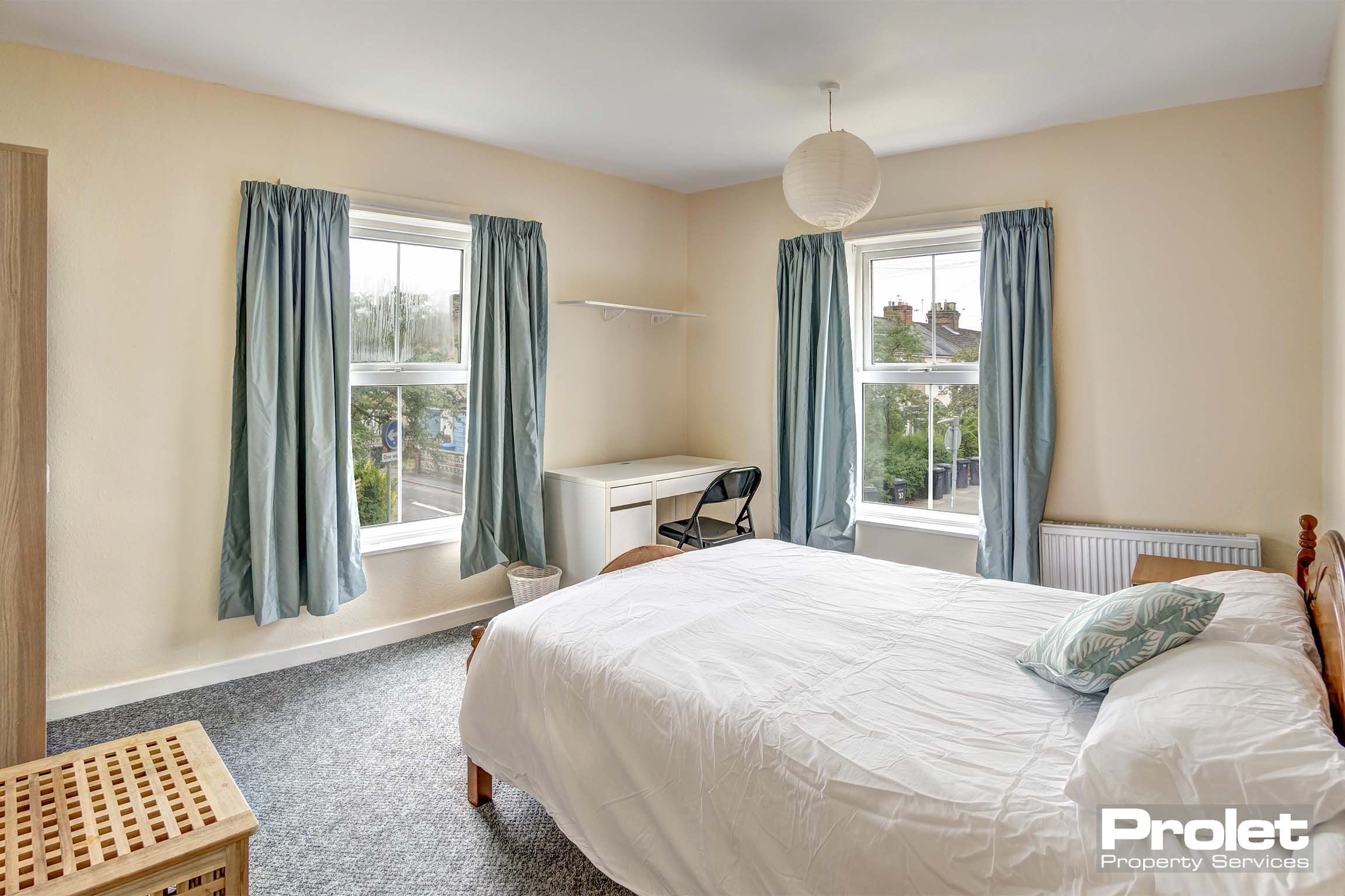 Large bedroom with double bed and desk