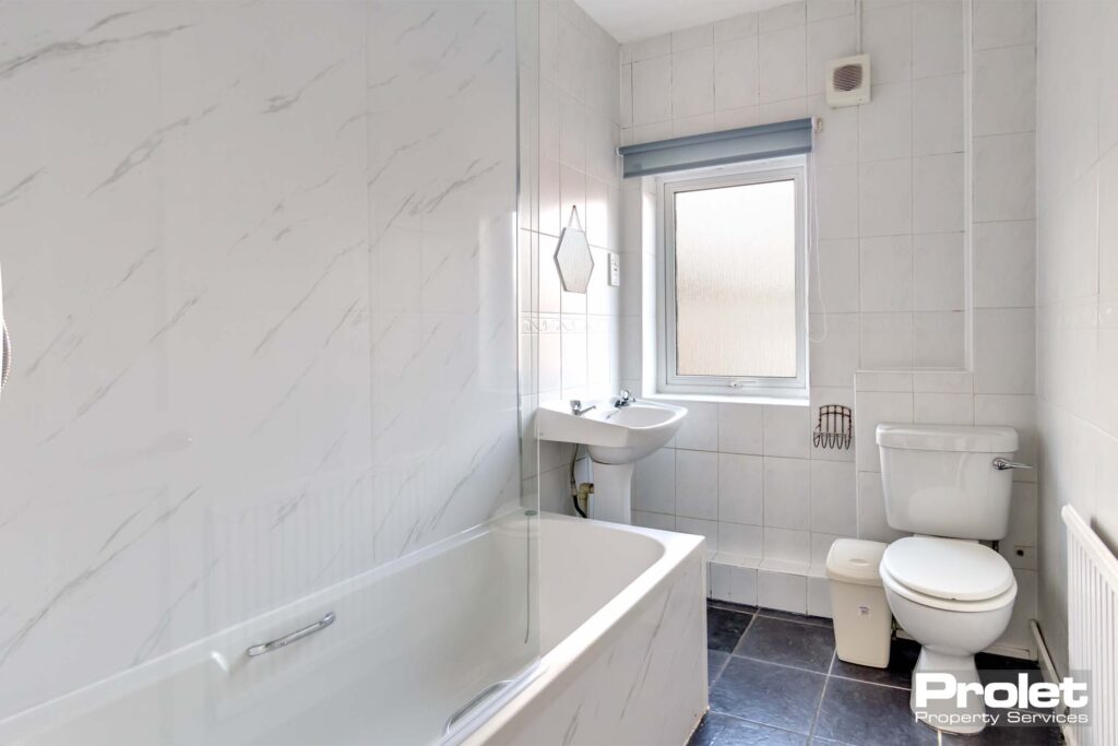 Upstairs family bathroom with shower over bath, toilet, and sink