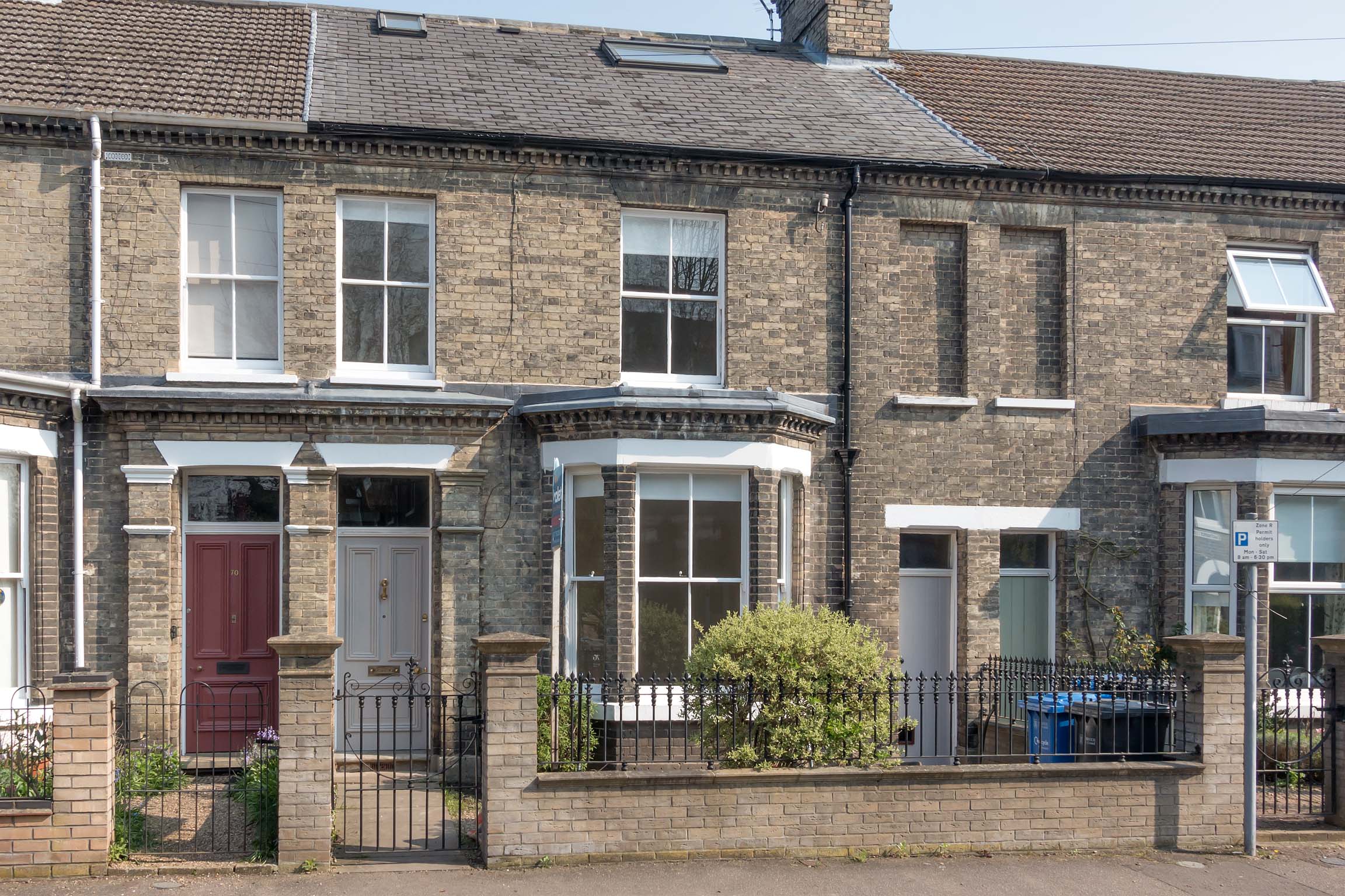 Brick house with front stoned garden and iron gate