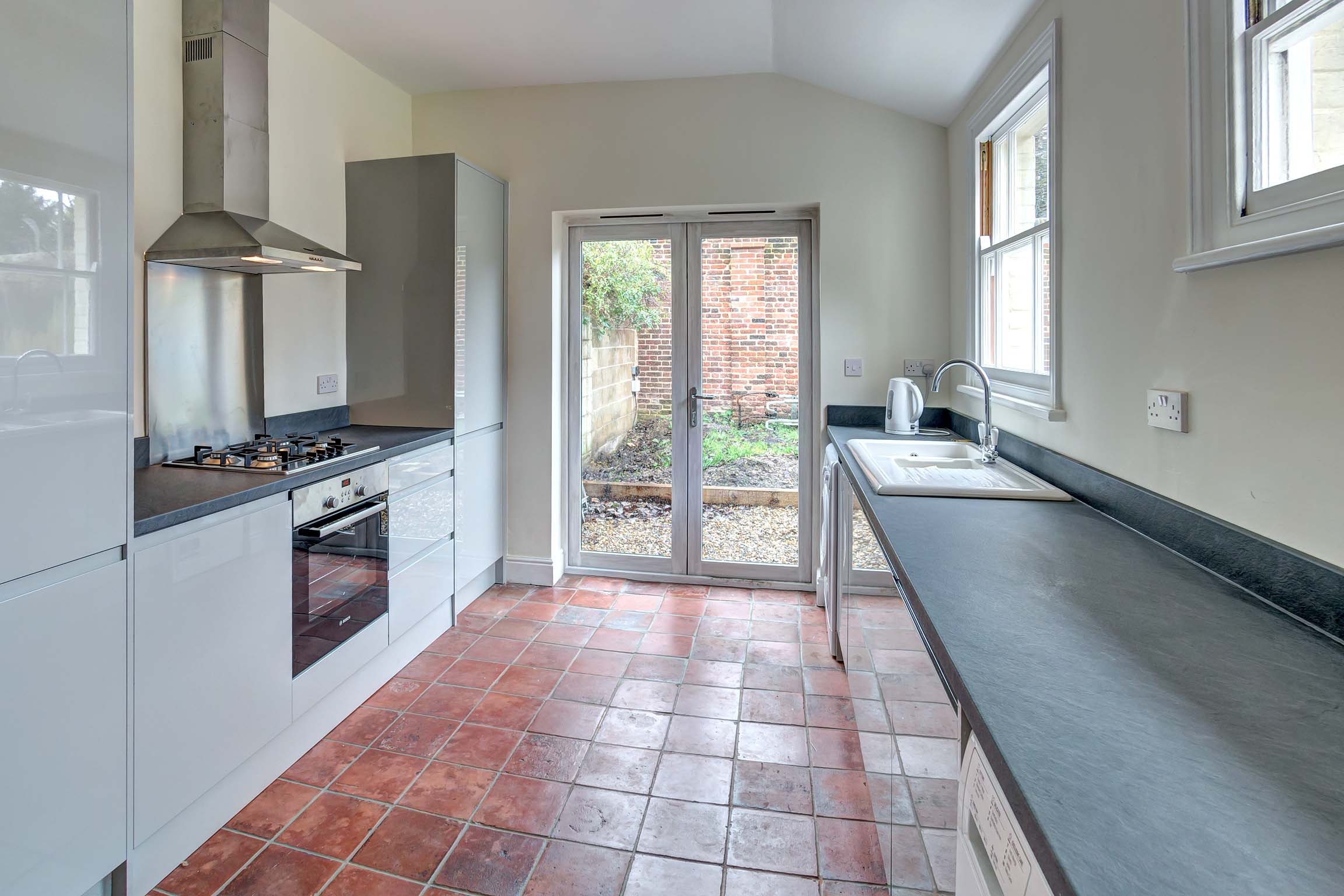 Kitchen with modern white cupboards and worktops