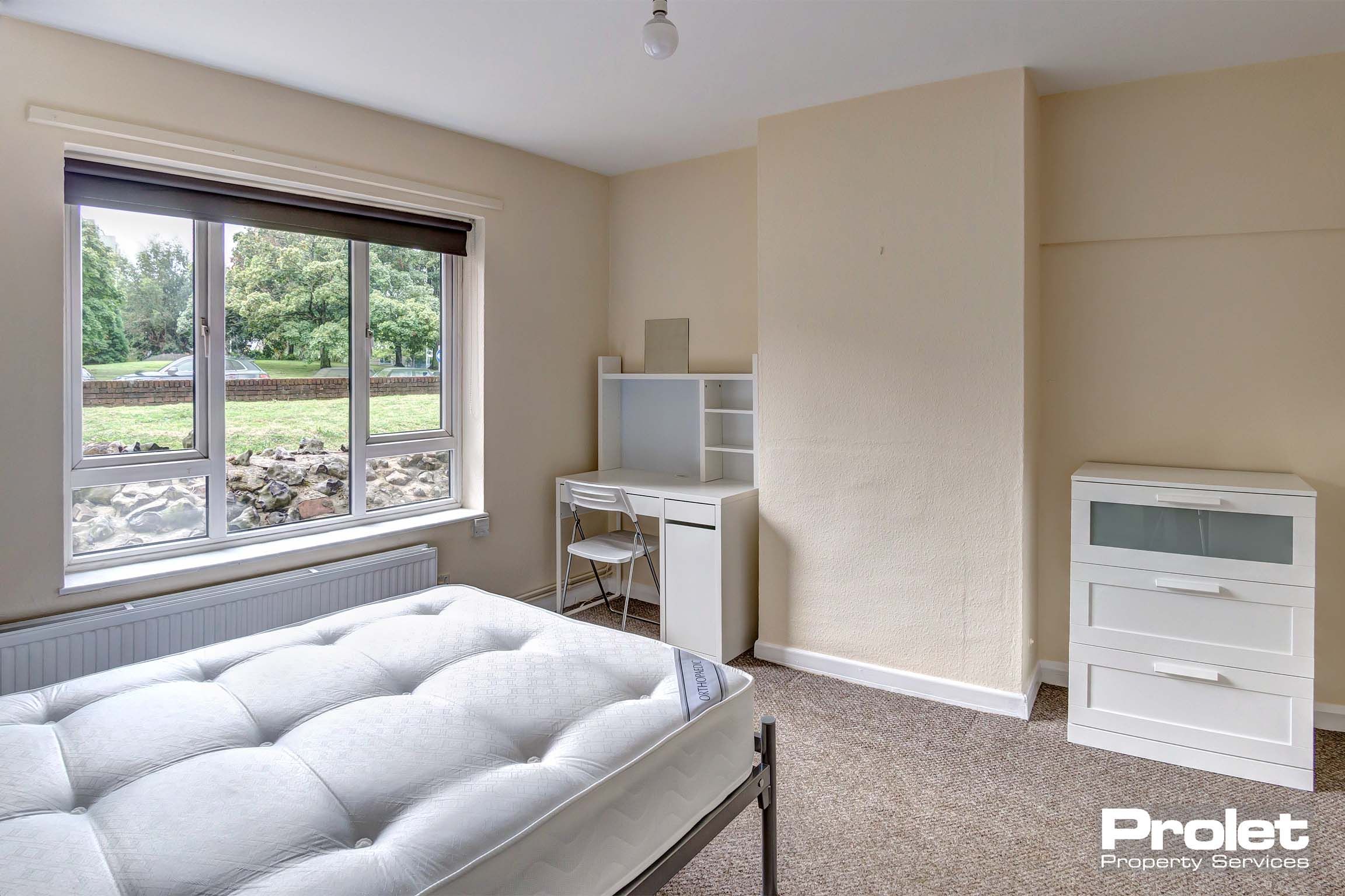Bedroom with double bed and white furnishings