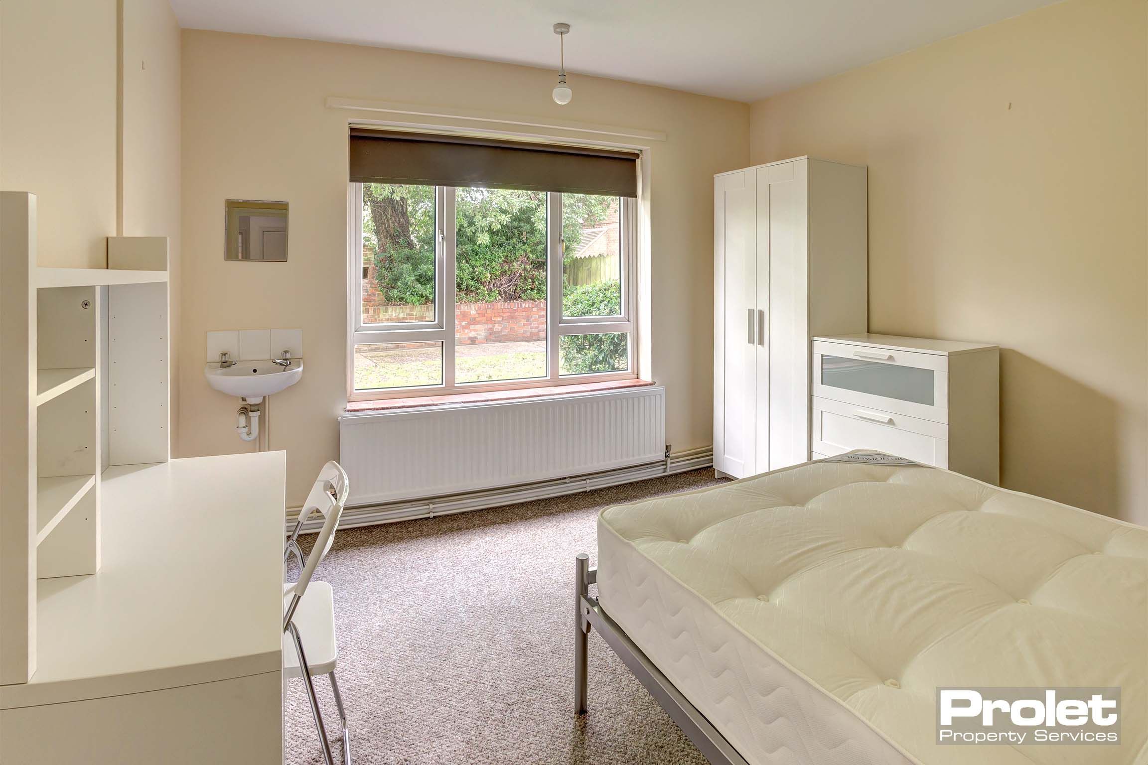 Bedroom with double bed and white furnishings