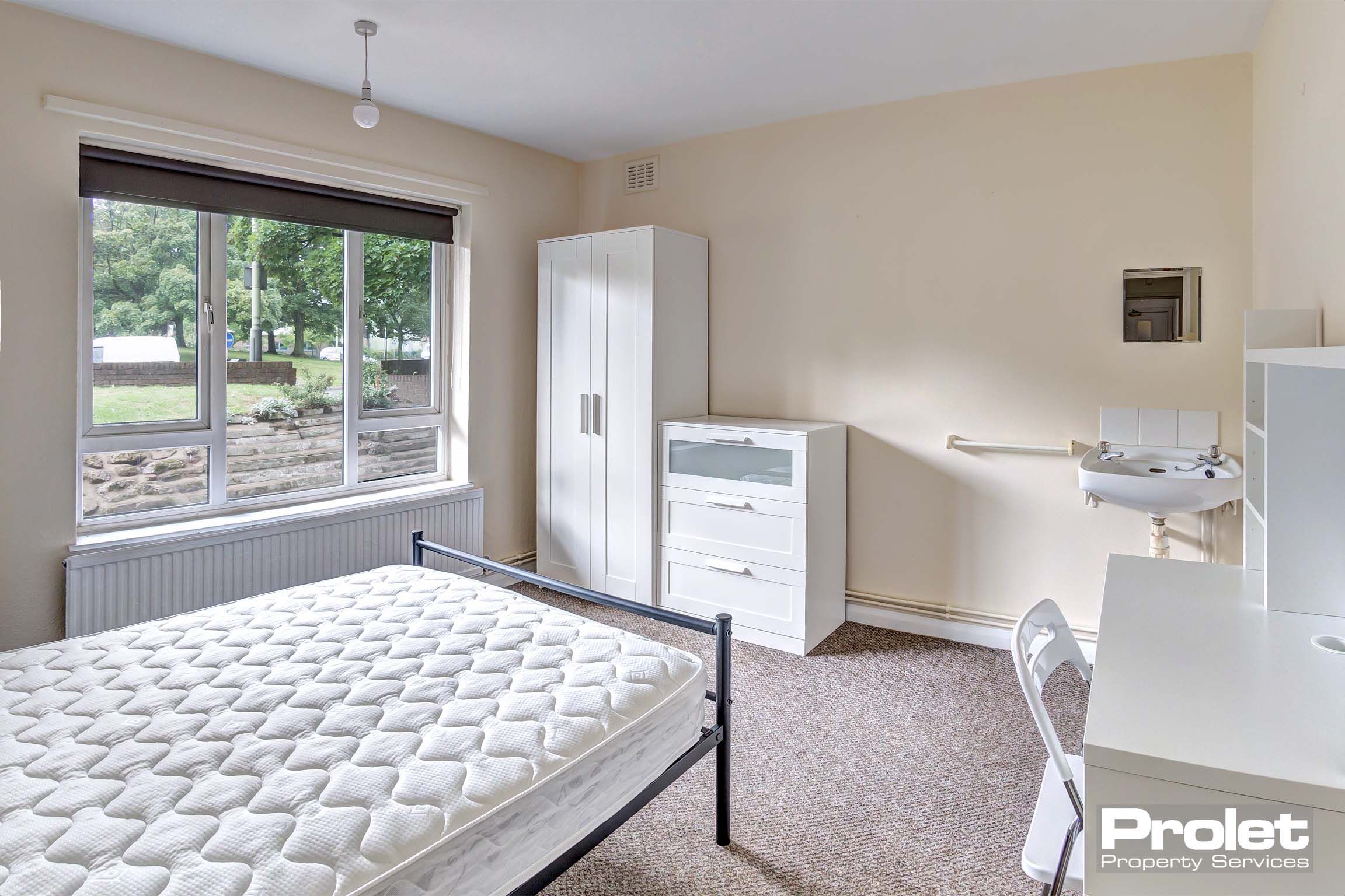 Bedroom with double bed and white furnishings
