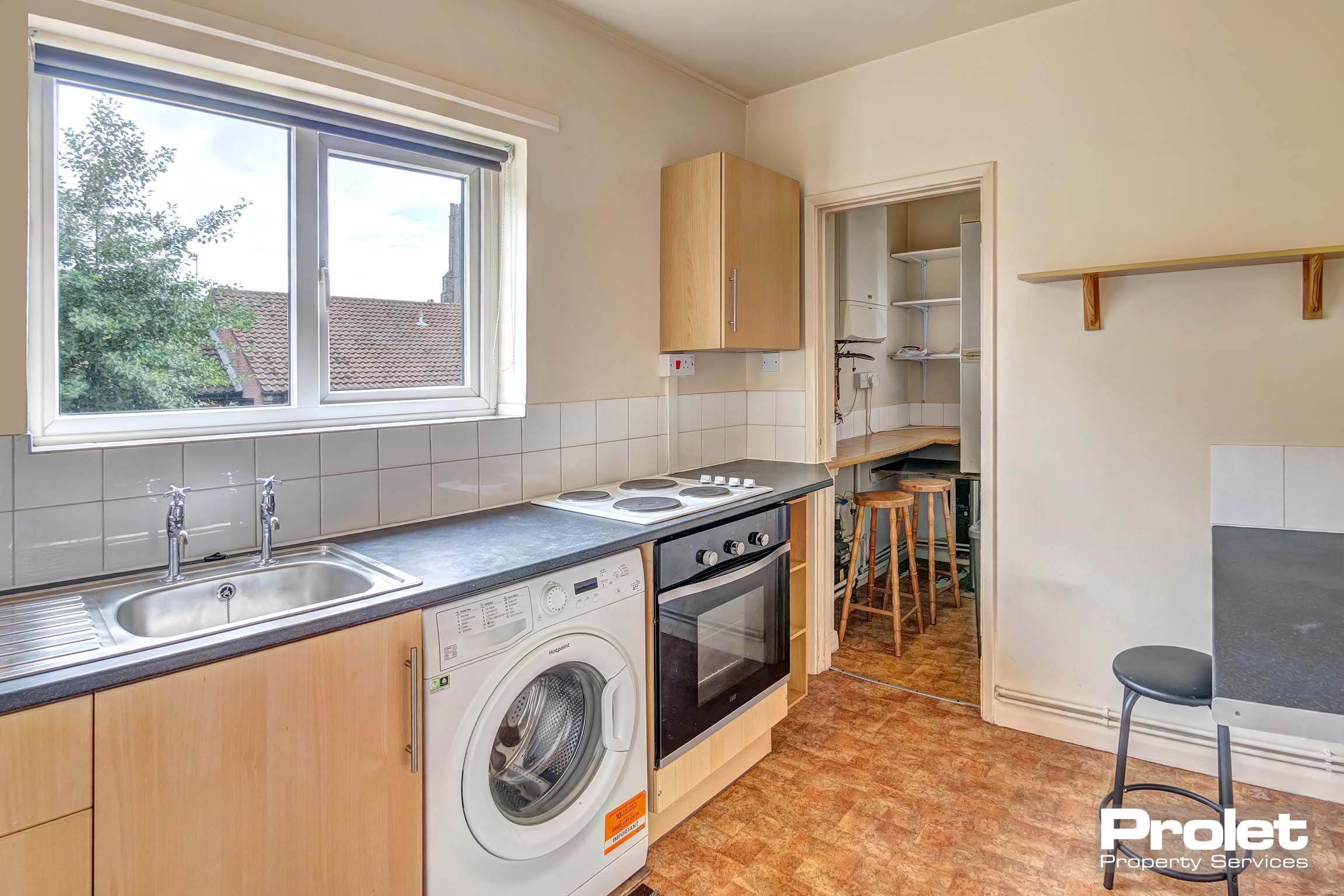 Kitchen with white goods, and wood effect cabinets