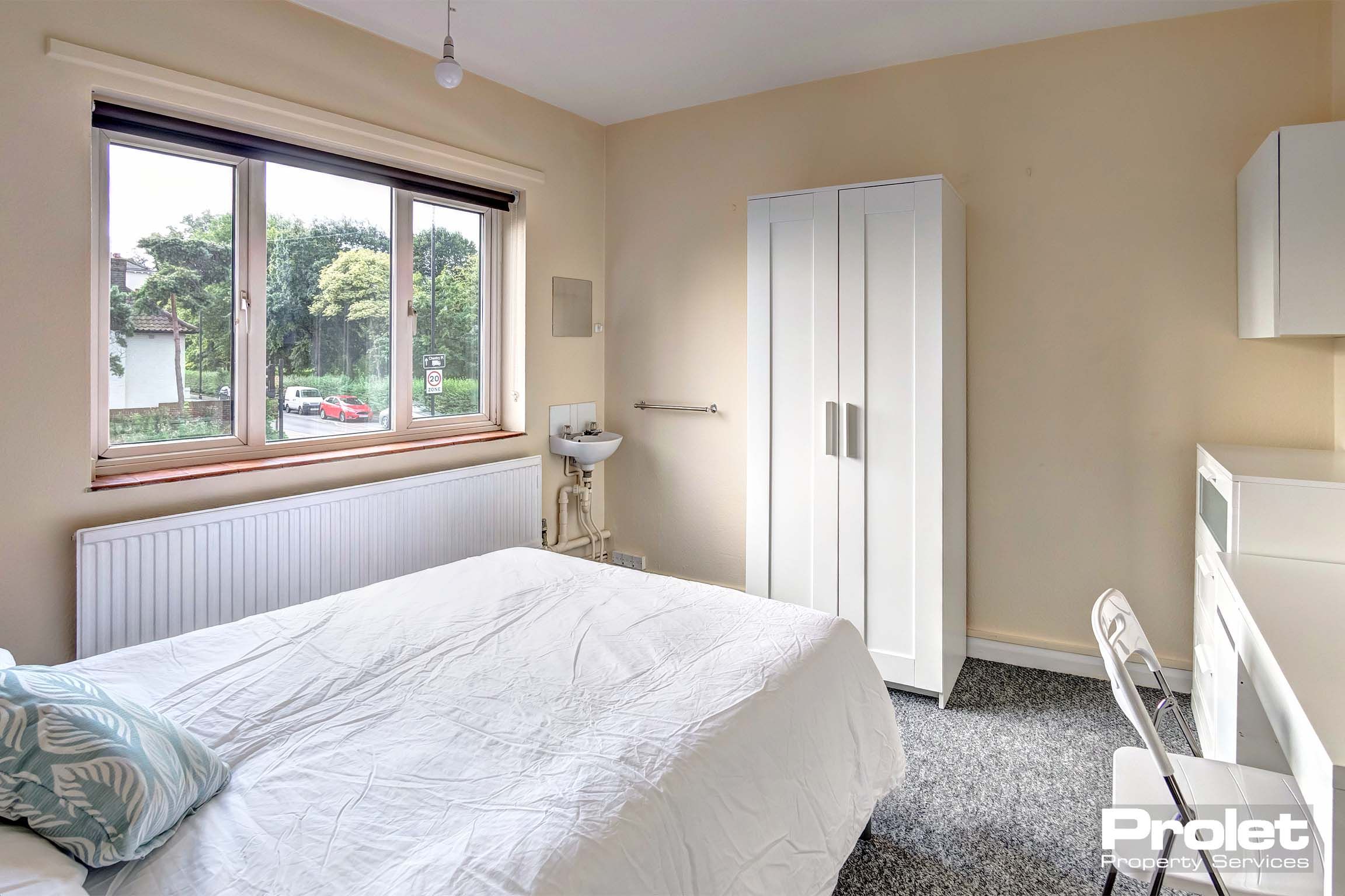 Bedroom with double bed and white furnishings