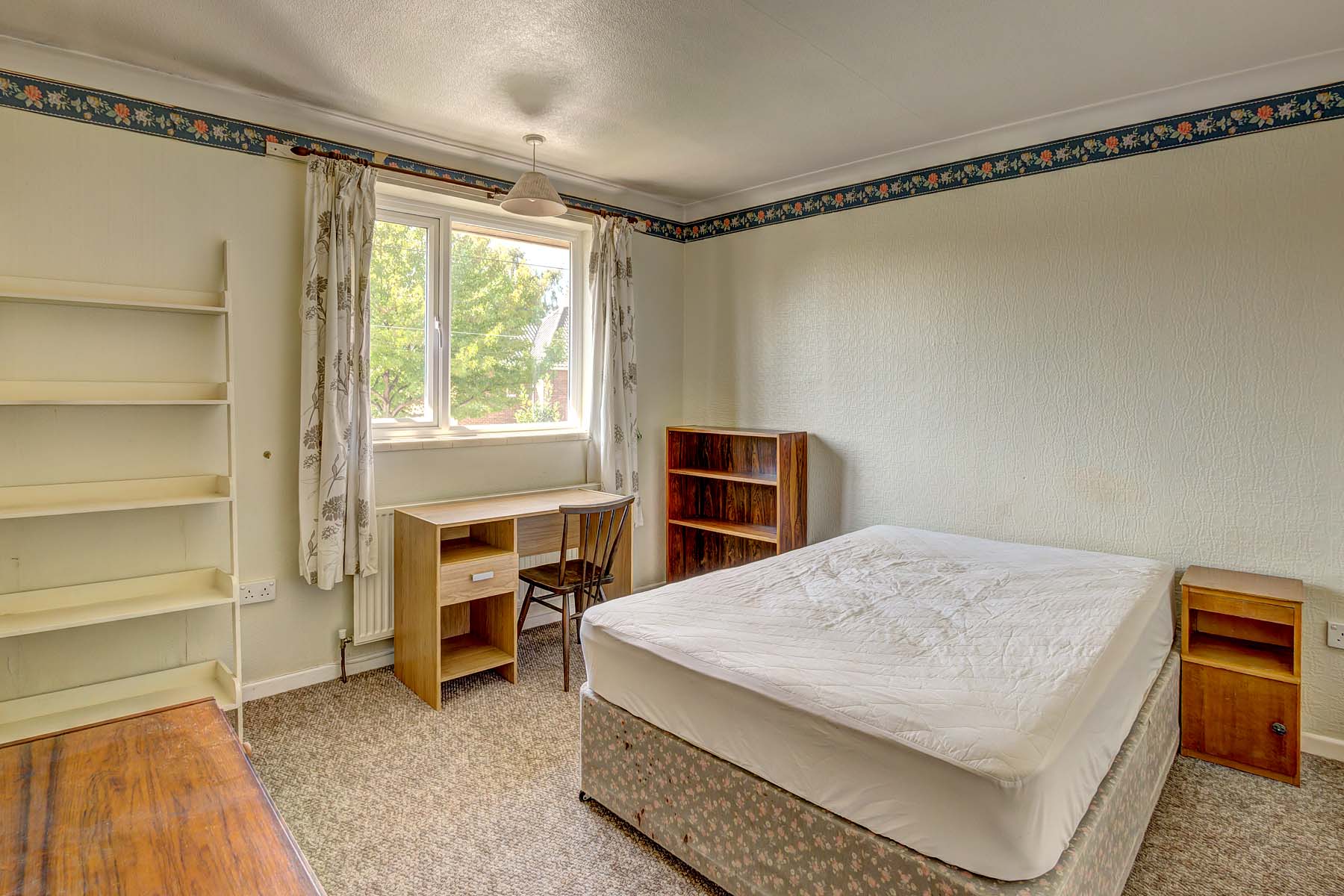 Double bedroom with cream carpet and magnolia walls