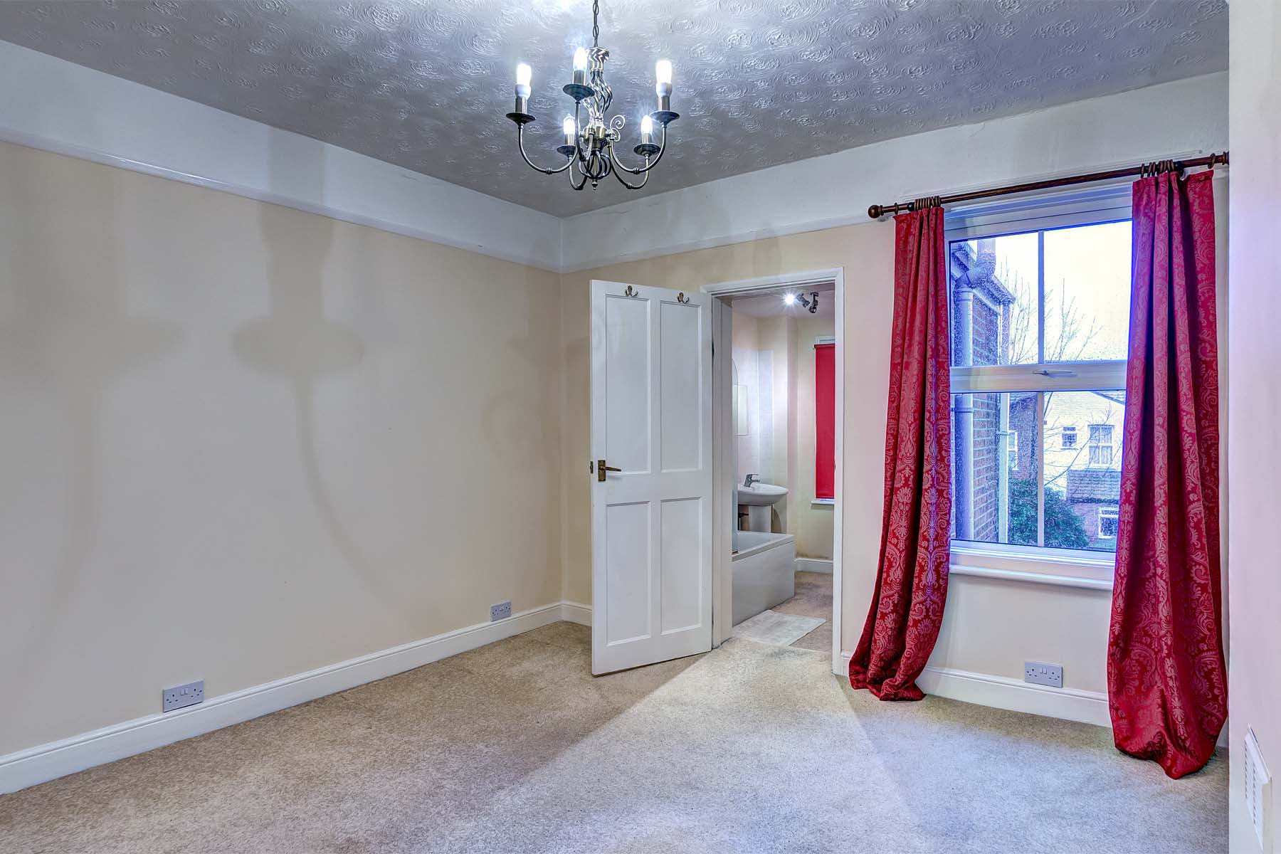 Cream carpet, magnolia walls & red curtains