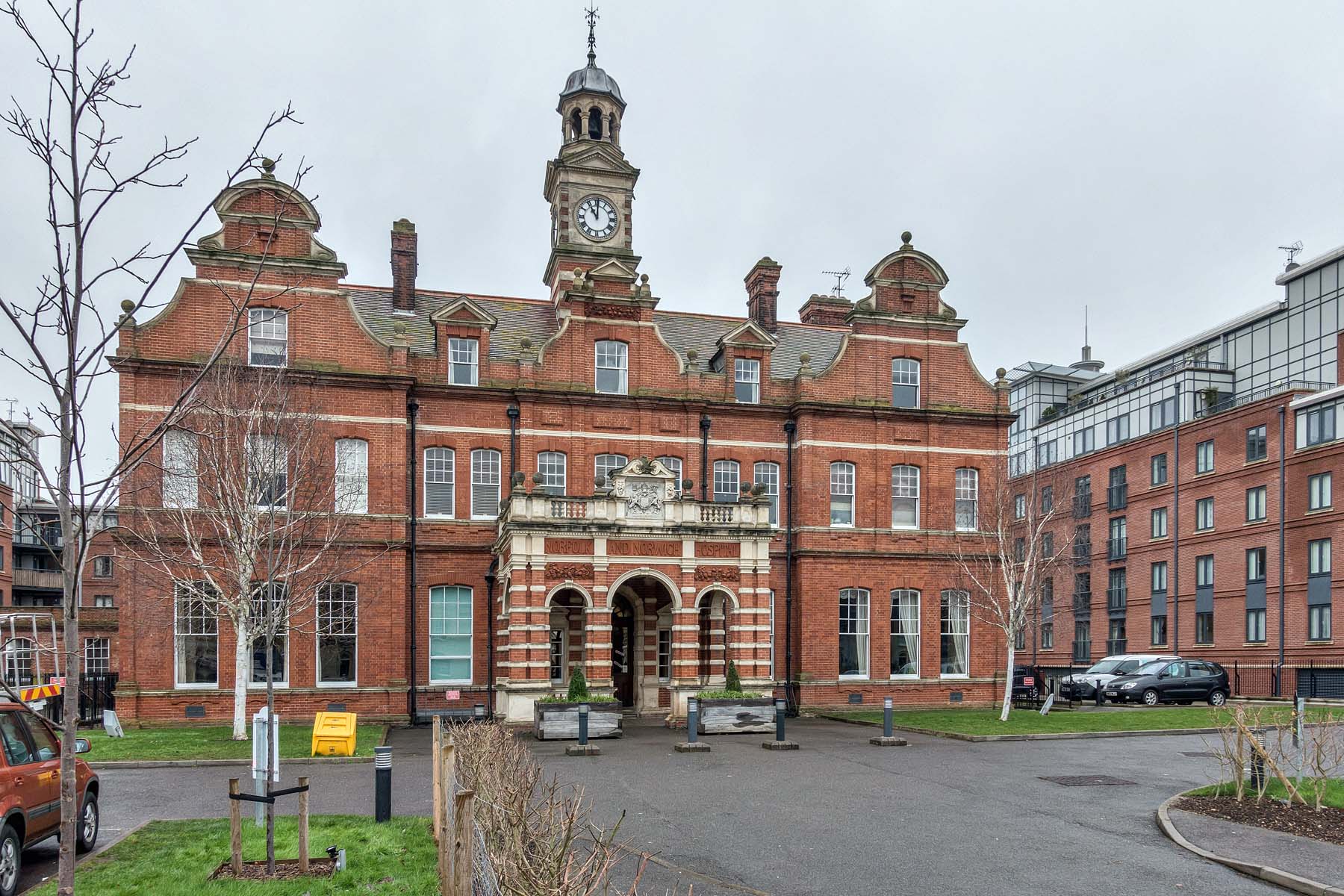 Large red brick building with intercom entry and ramped entrance