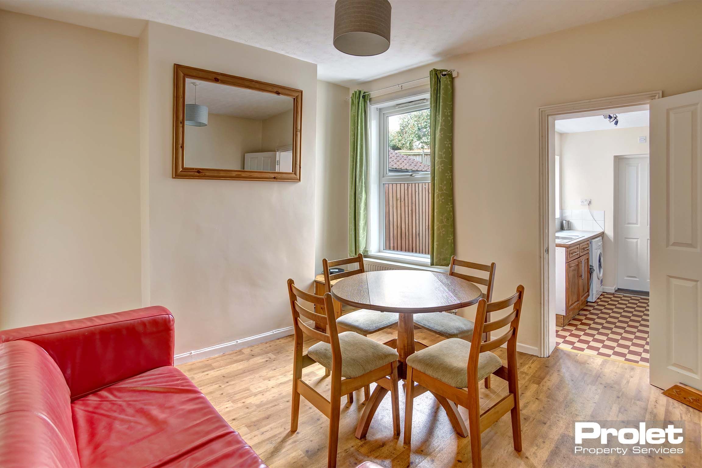 Dining room with table and chairs leading to kitchen