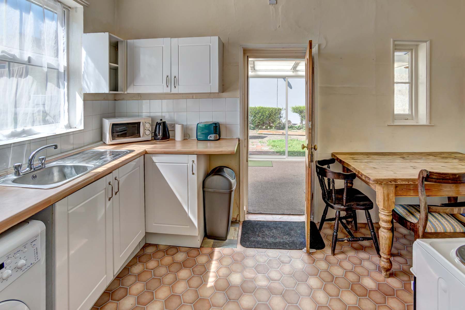 Kitchen with white cabinets and dining area