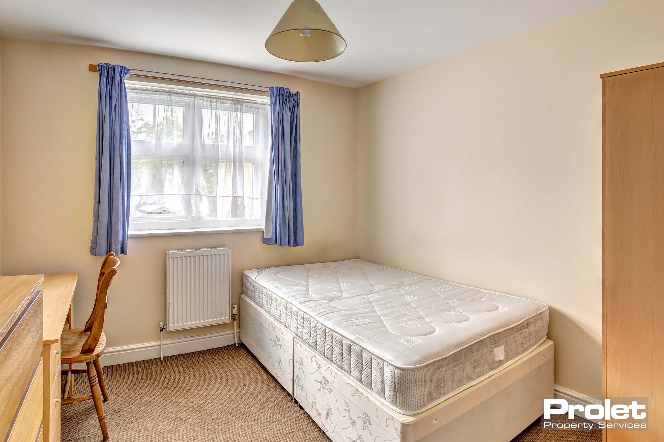 Bedroom with divan bed and wooden desk