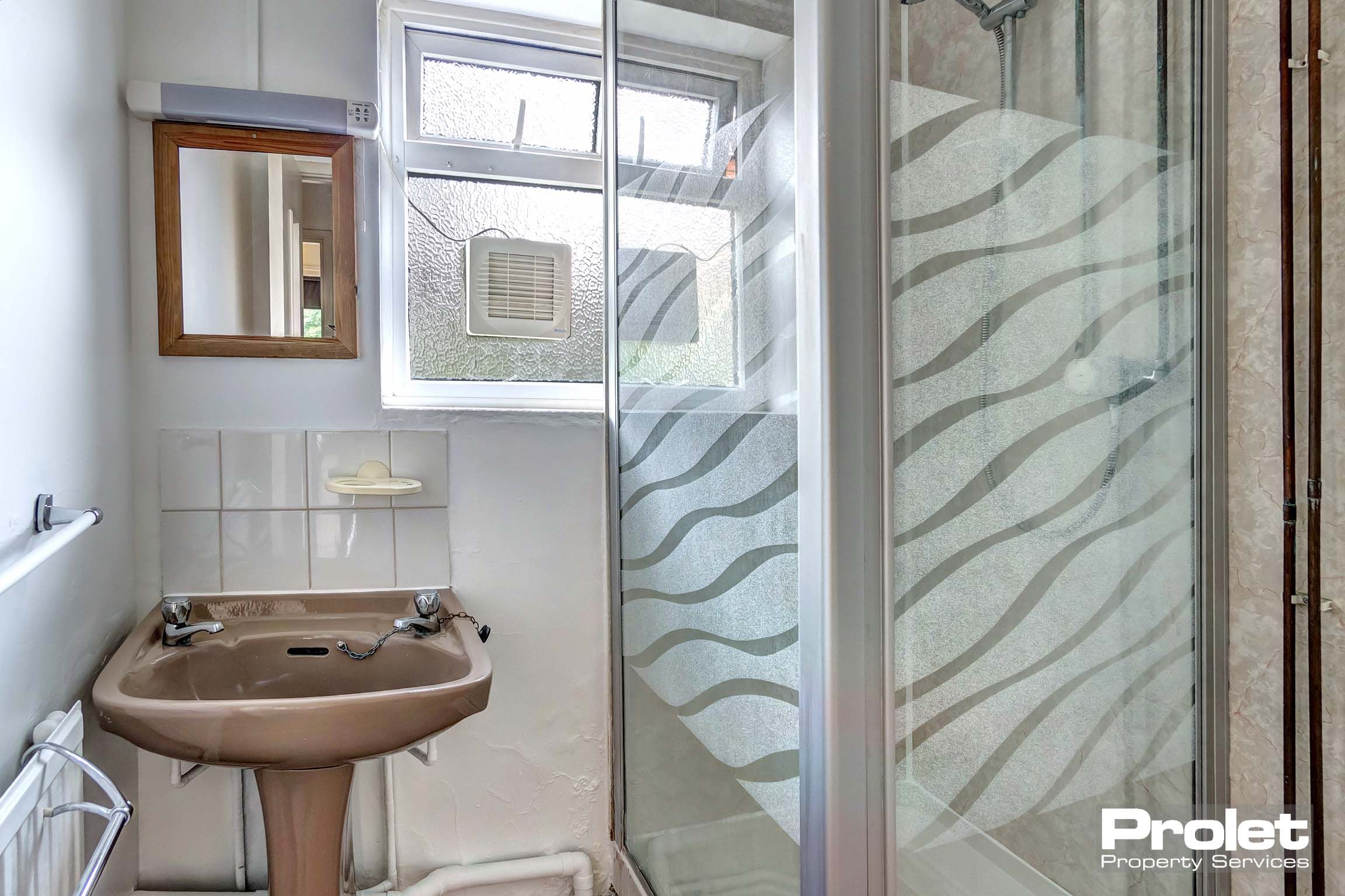 Bathroom with shower cubicle and sink