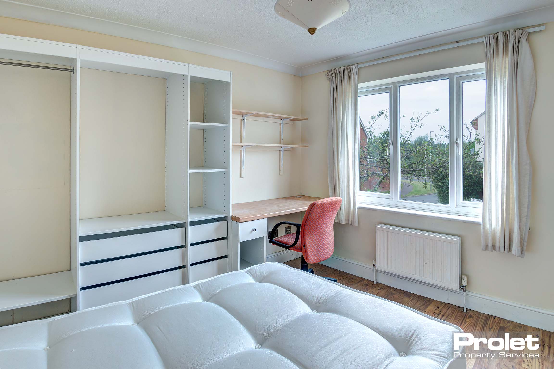 Bedroom with white storage units