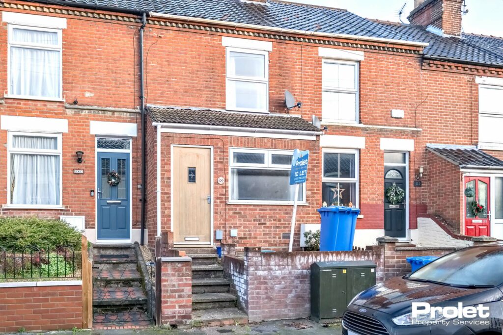 Terraced house with steps leading to front door.