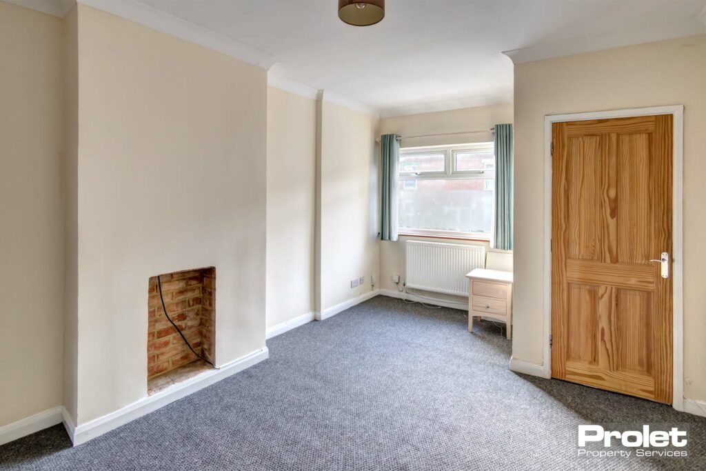 Lounge with box bay window, grey capet, and cream walls