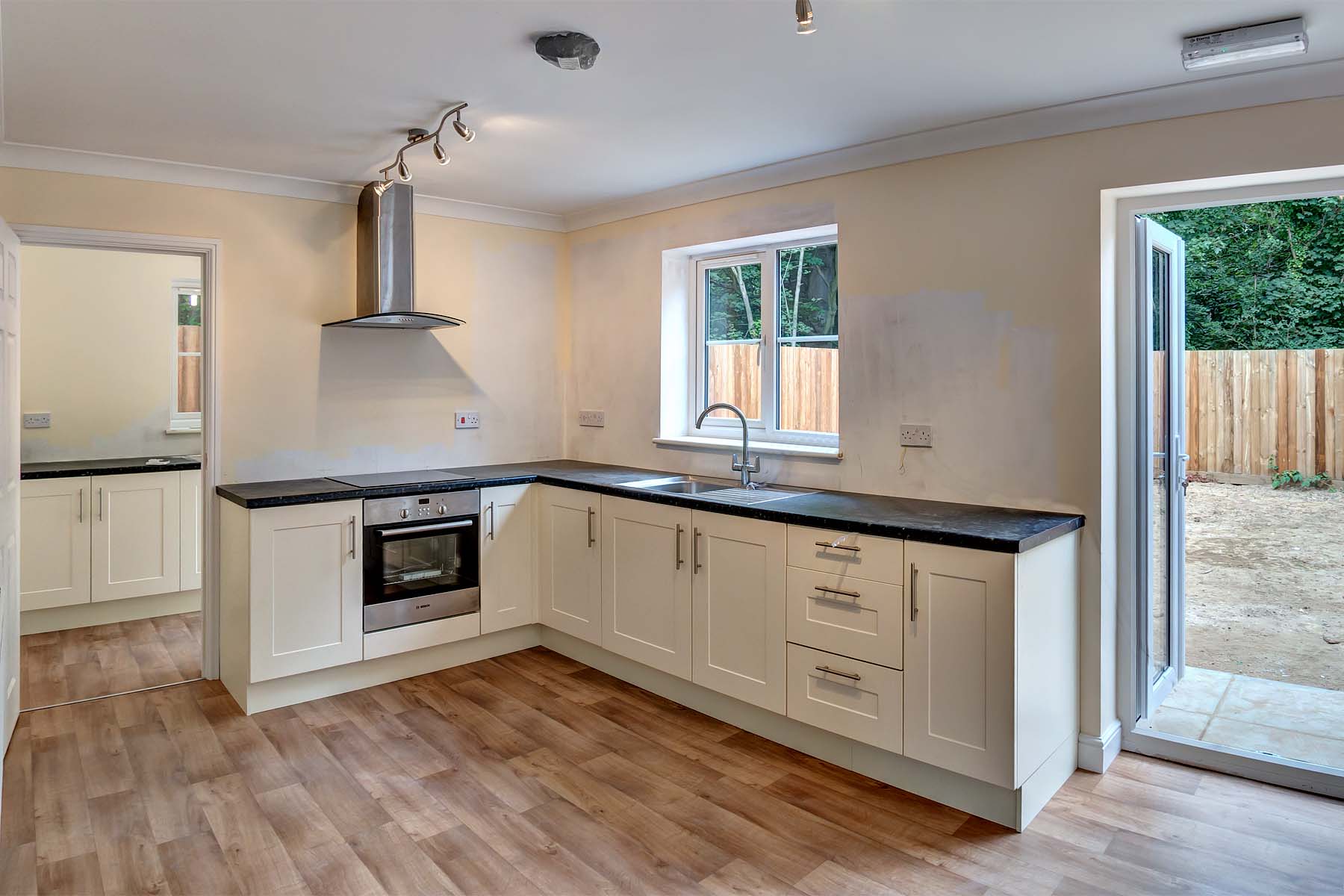 Modern kitchen with white cabinets and black worktop