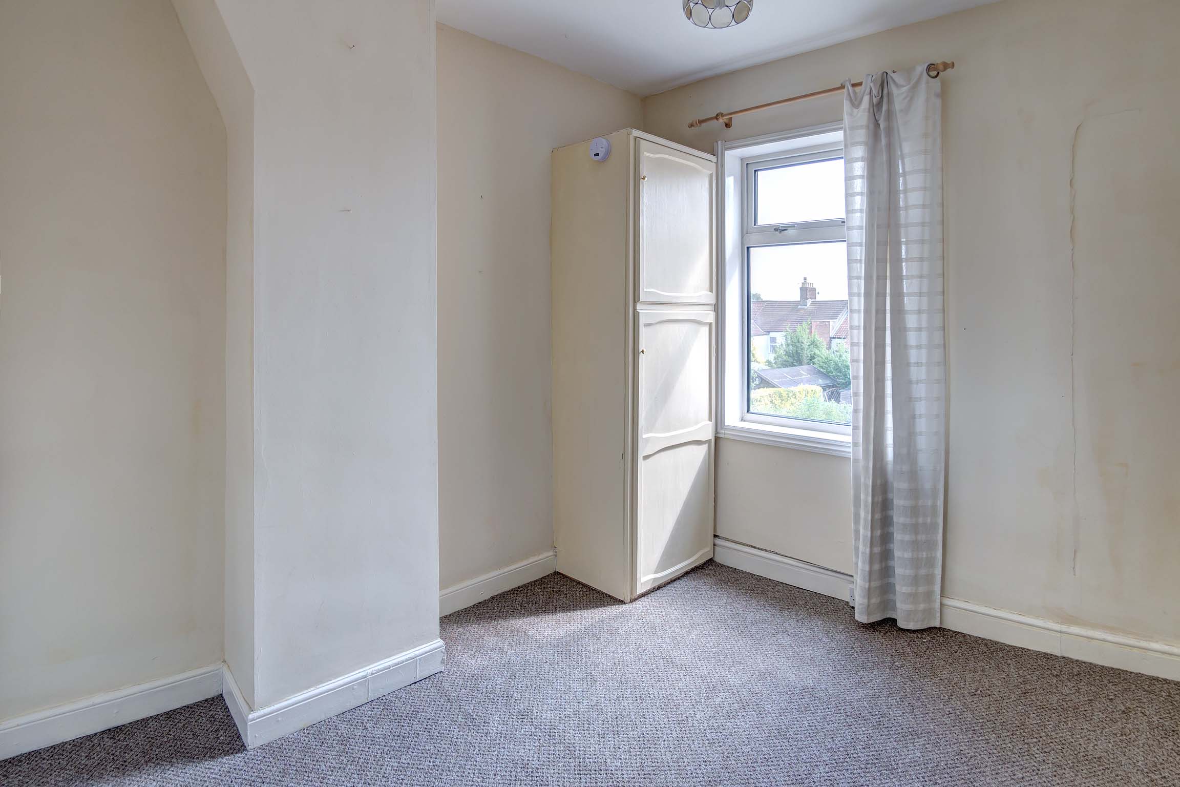 Brown carpet with off white walls.