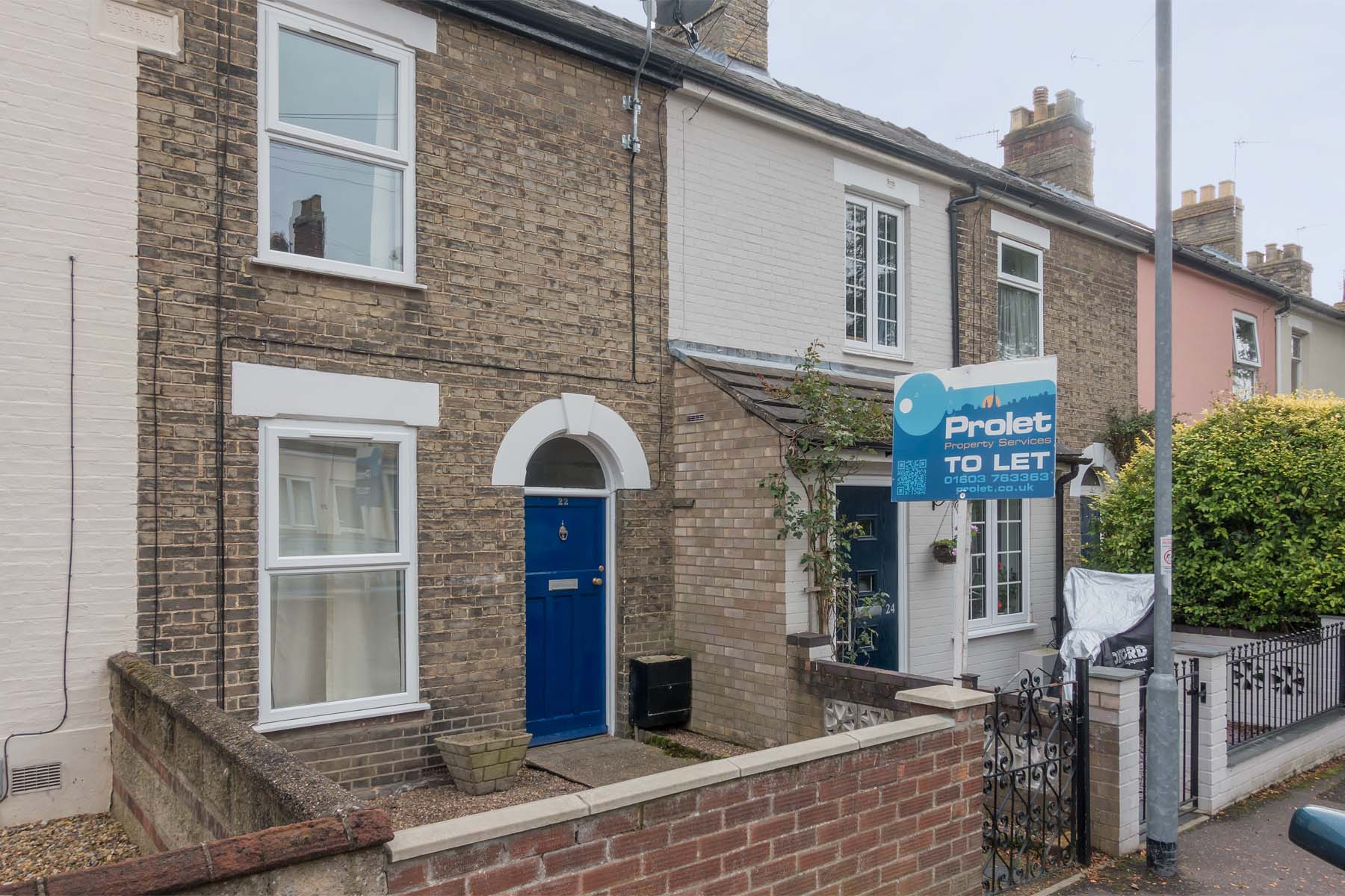 Brick building with enclosed front garden